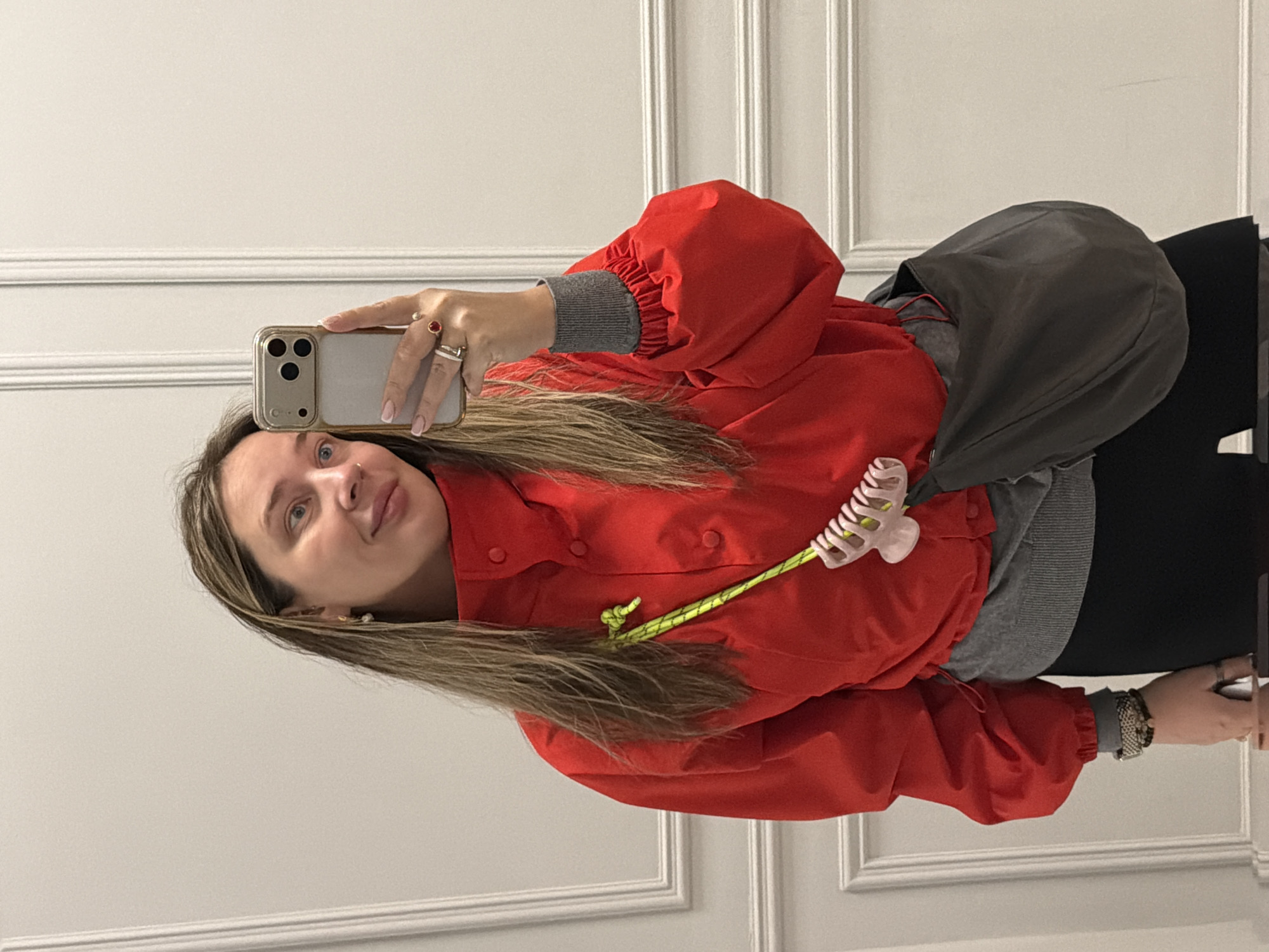 Woman takes morning selfies in red jacket, Moscow