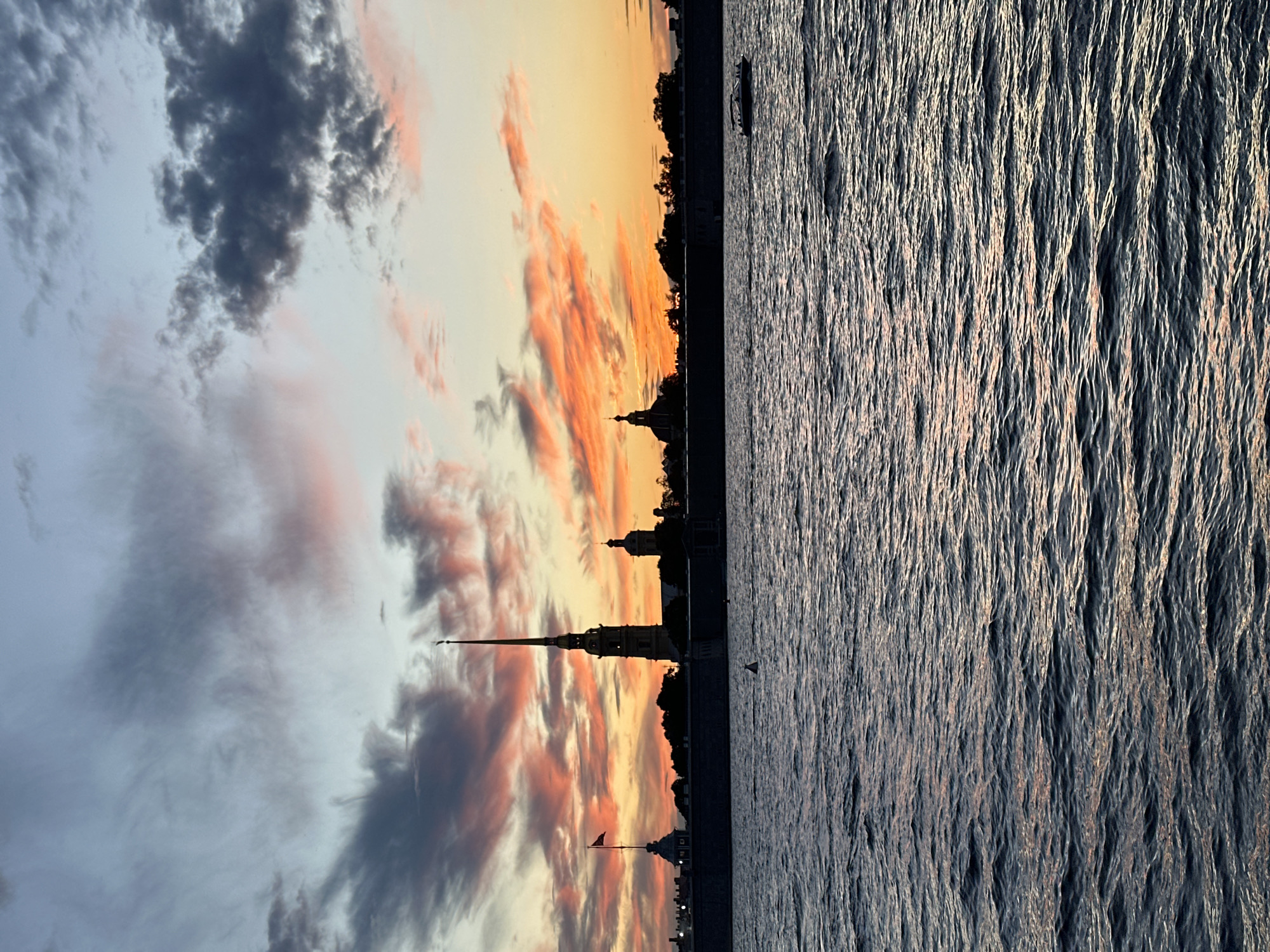 City skyline at golden hour, sky ablaze with color