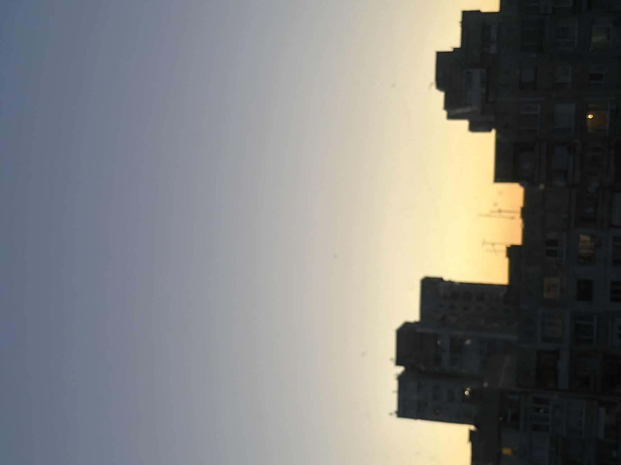 Dusk from a city apartment, indoors and out