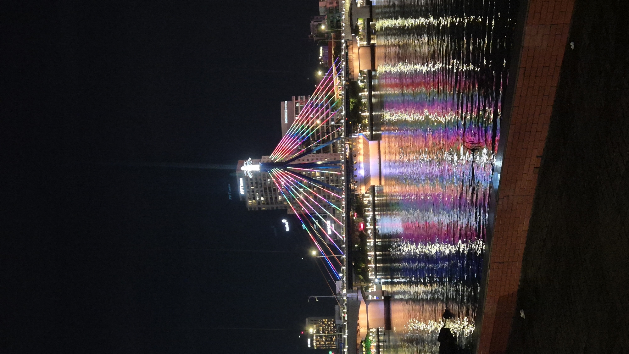 Dragon Bridge glows with multicolored lights over the Hàn River