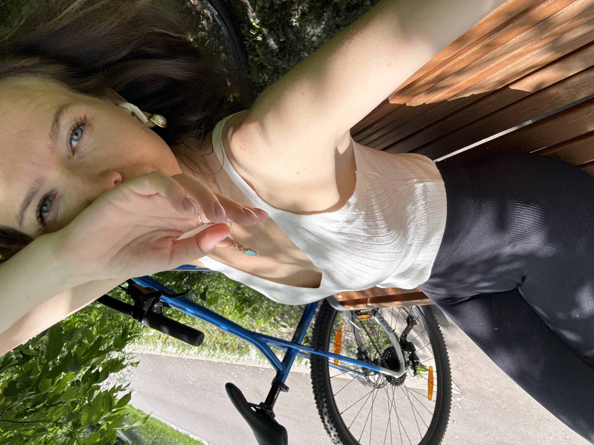 Woman cycles, rests in Moscow park during sunny morning
