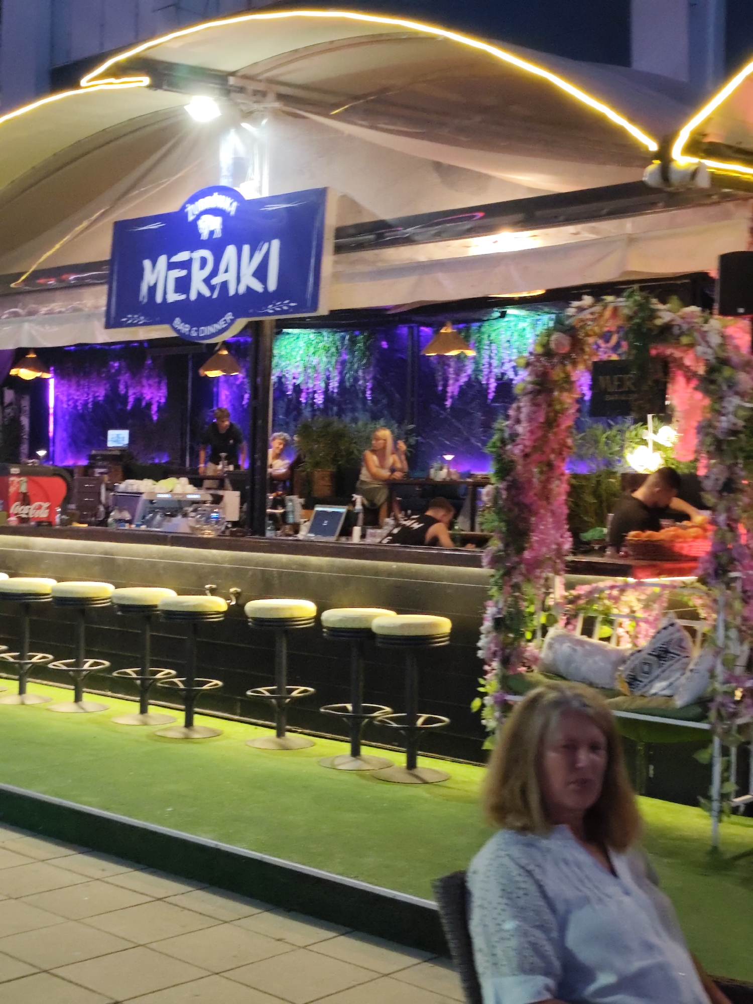Nesebar nightlife: bars, neon, parked cars, and ice cream