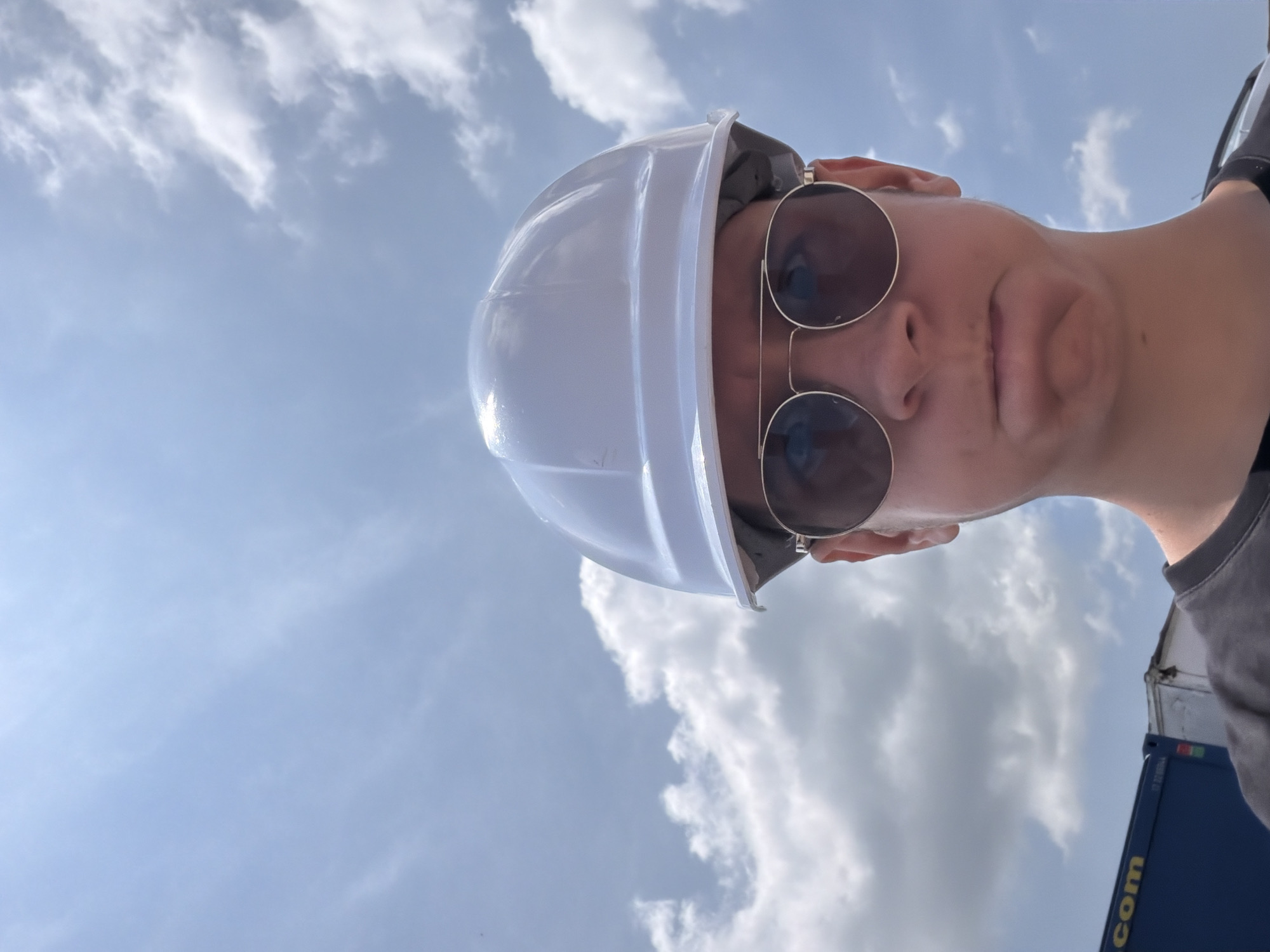 Hard hat selfie against a cloudy sky in Lozen, Bulgaria