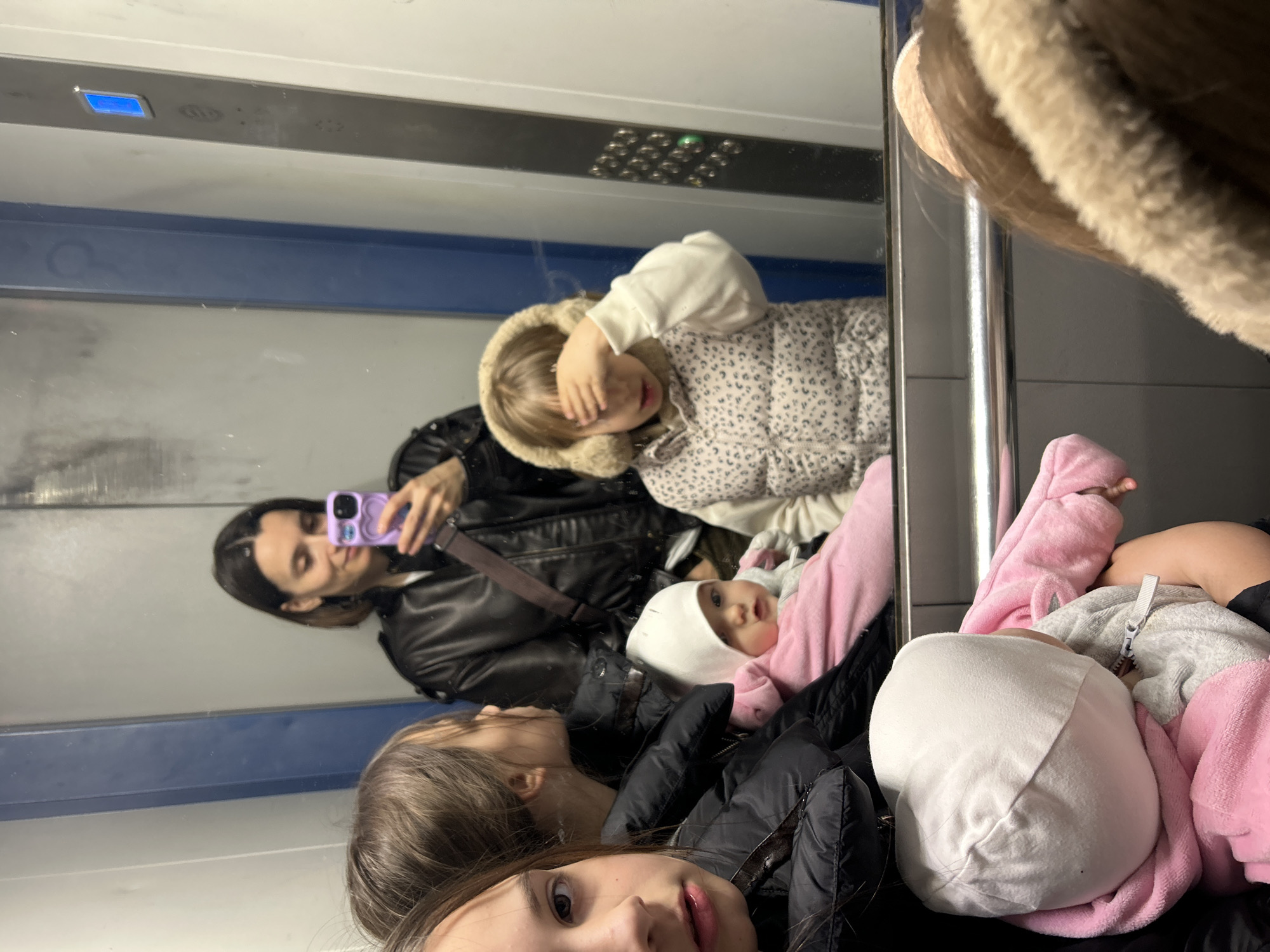 Woman takes selfie with children in Moscow transit