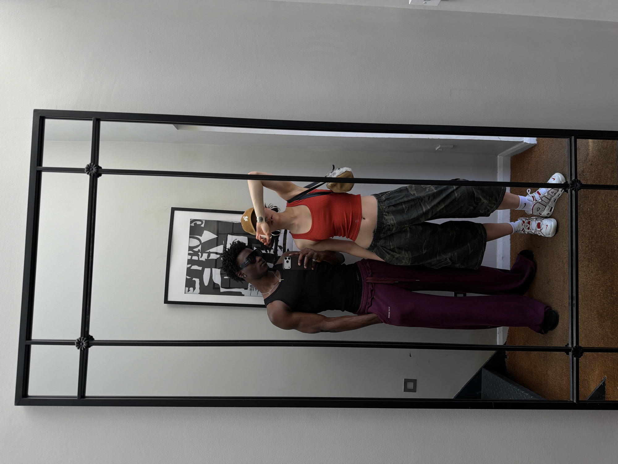 Couple reflected in gridded mirror captured in London