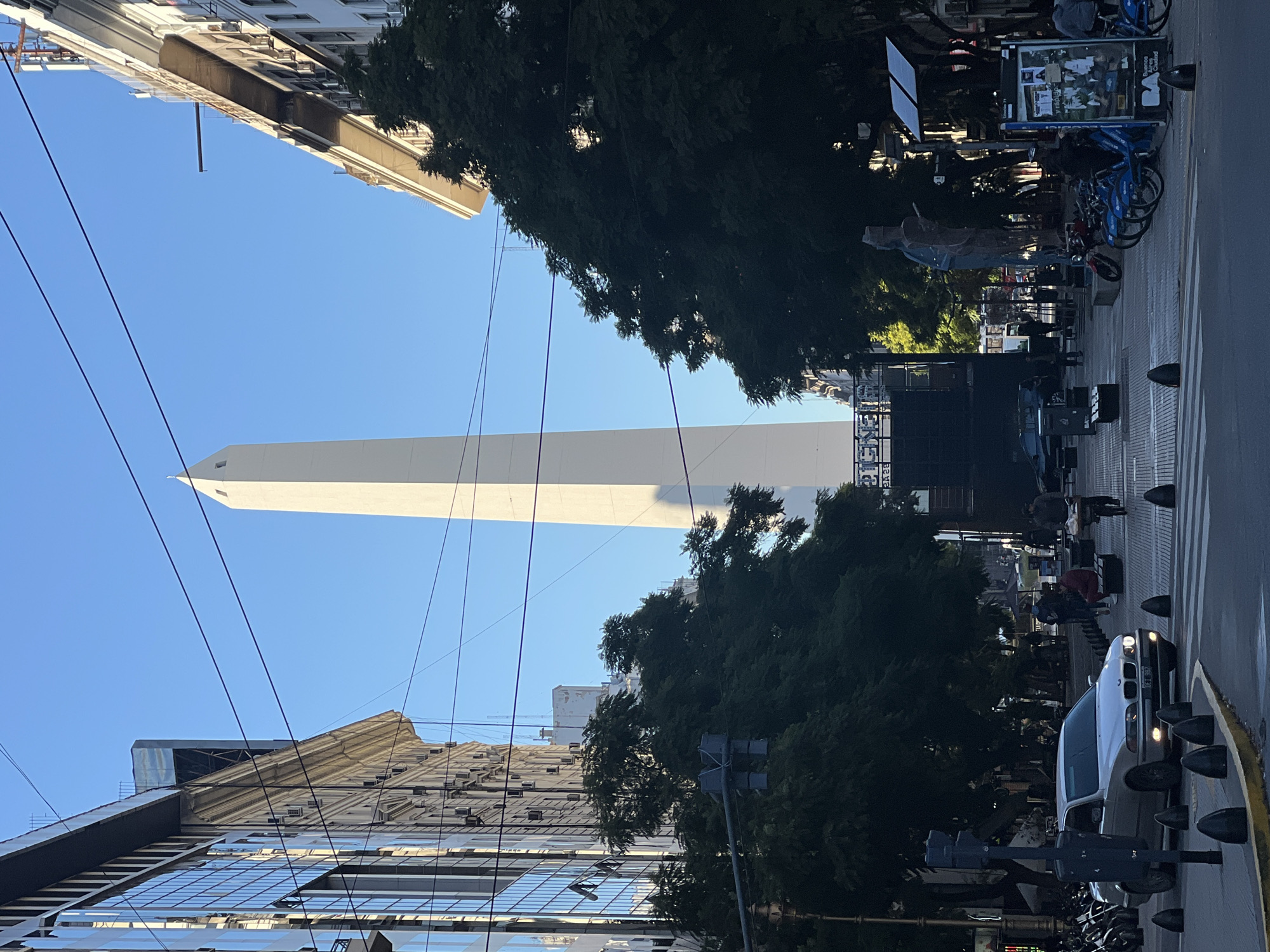 Tourist documents Buenos Aires landmarks during midday walking tour