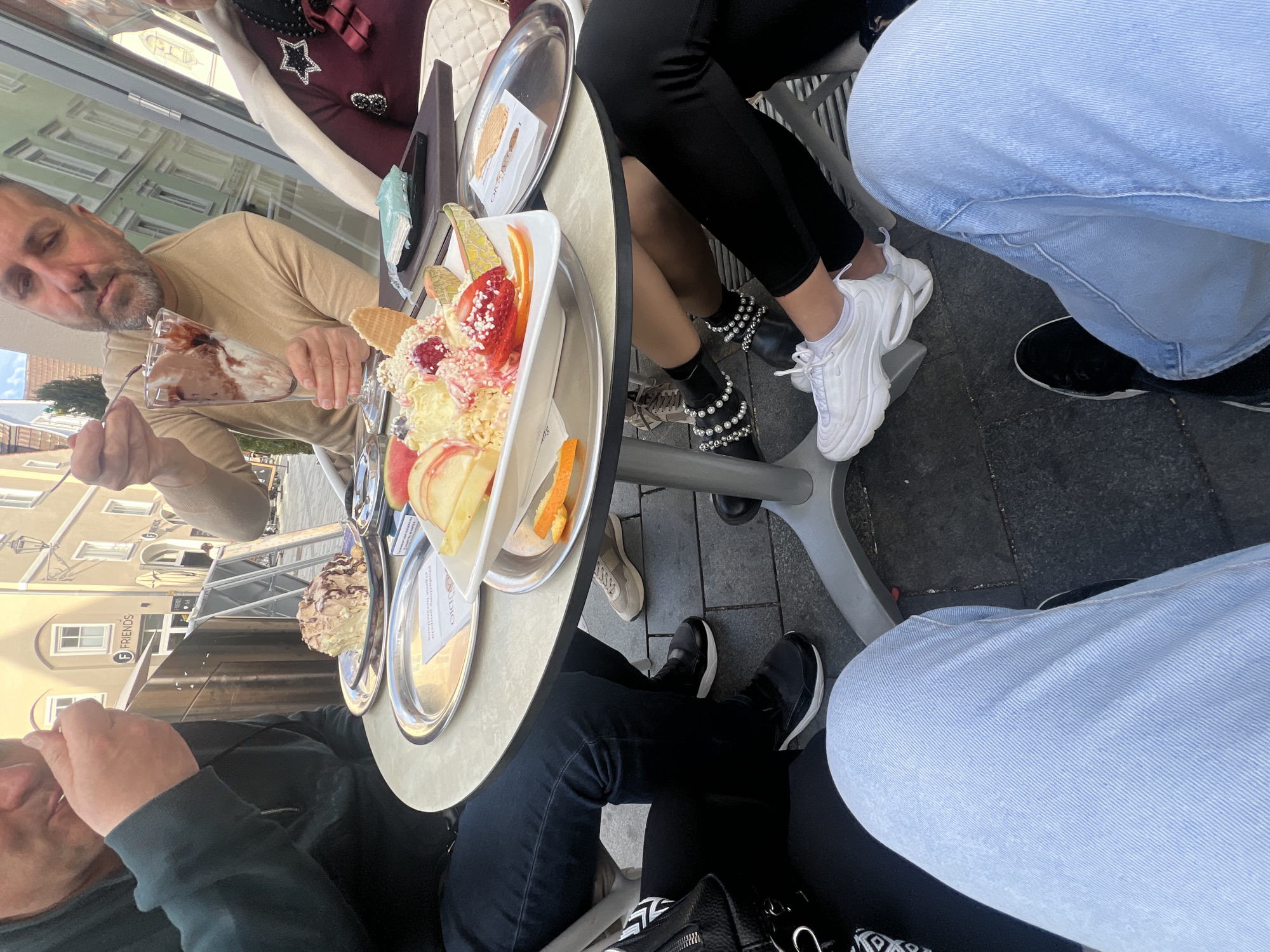 Outdoor cafe diners enjoy ice cream in Memmingen