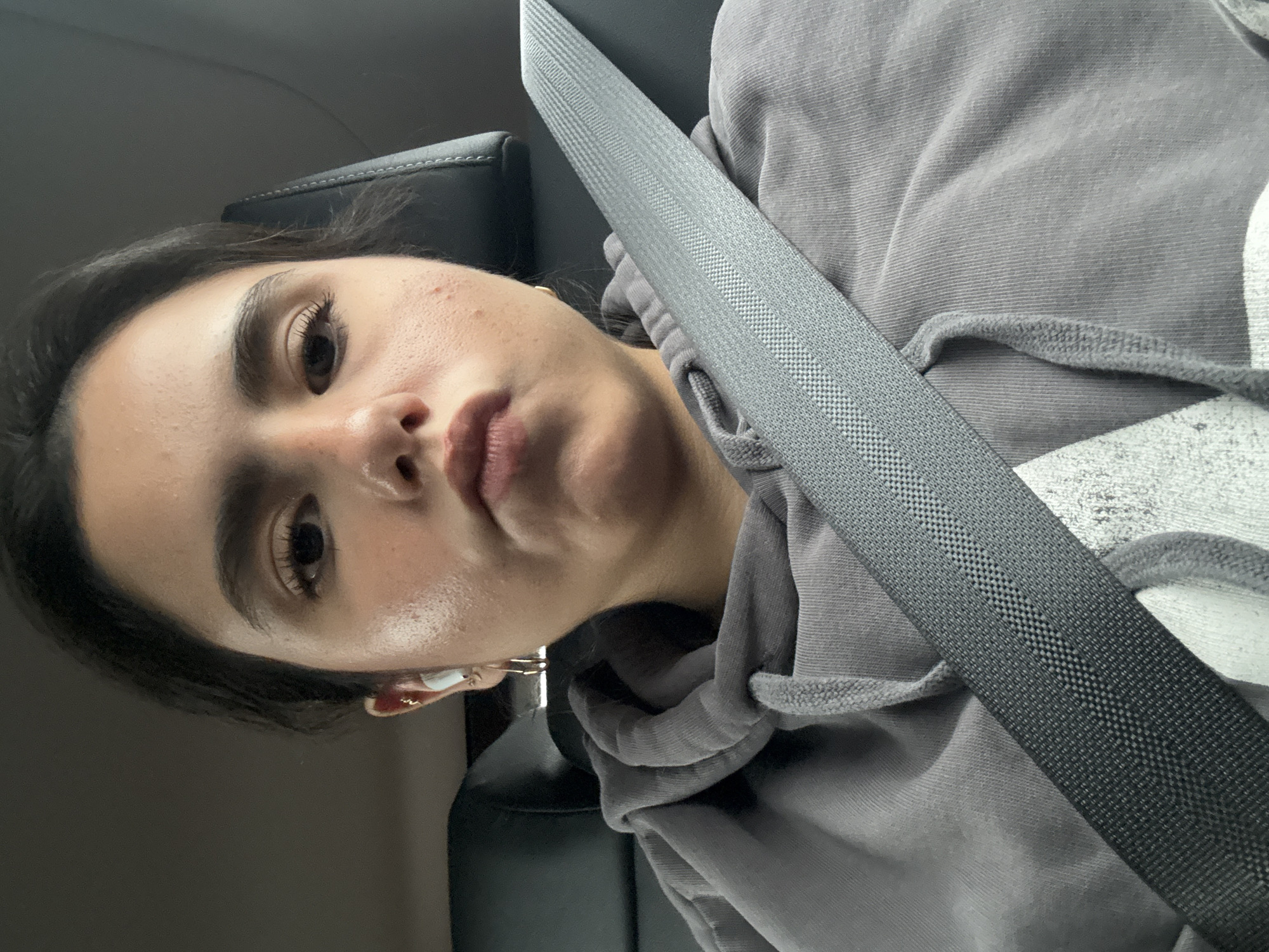 Woman takes selfie in car passenger seat in Austin