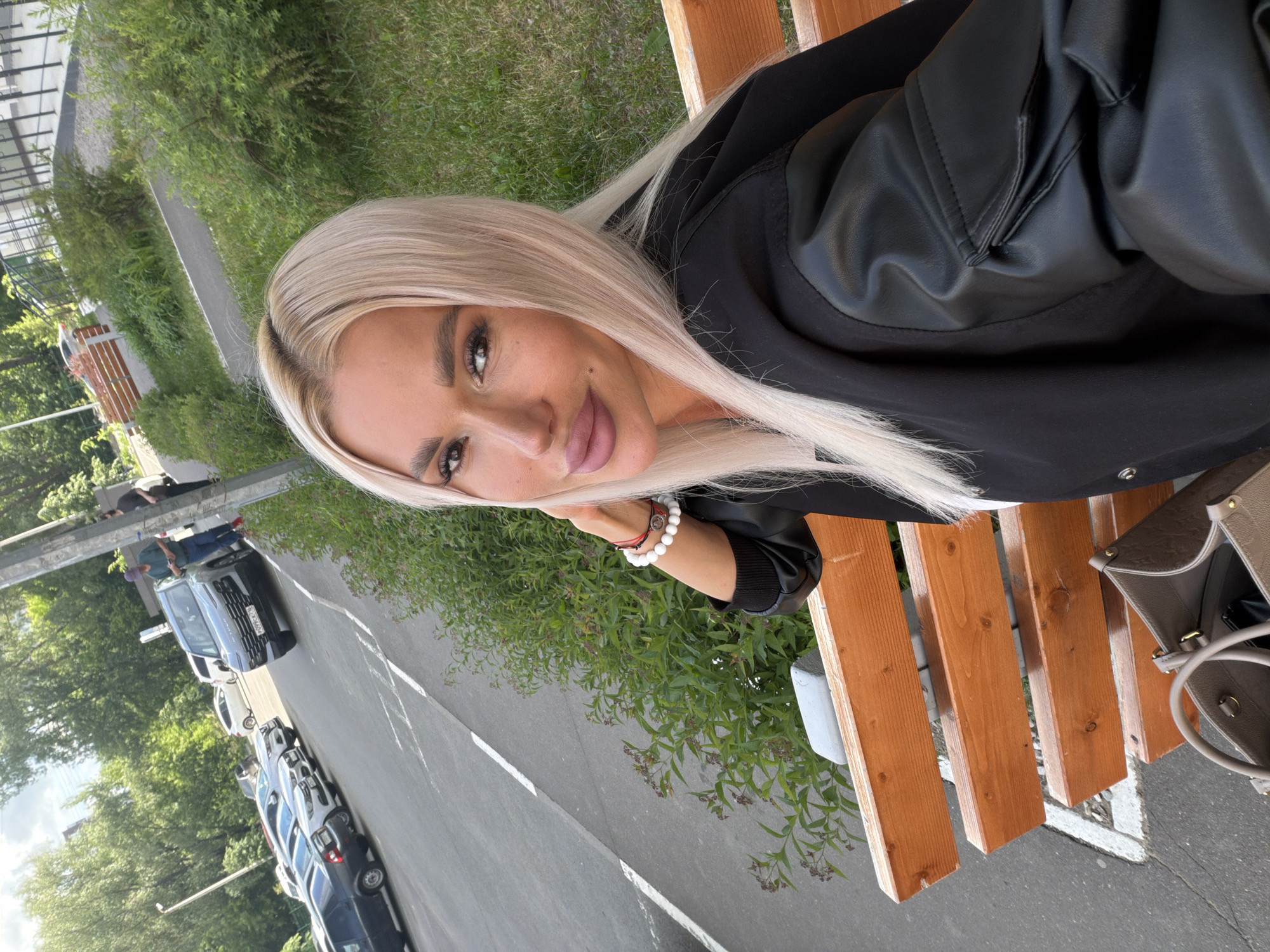 Woman sits on bench in Grebeni urban area
