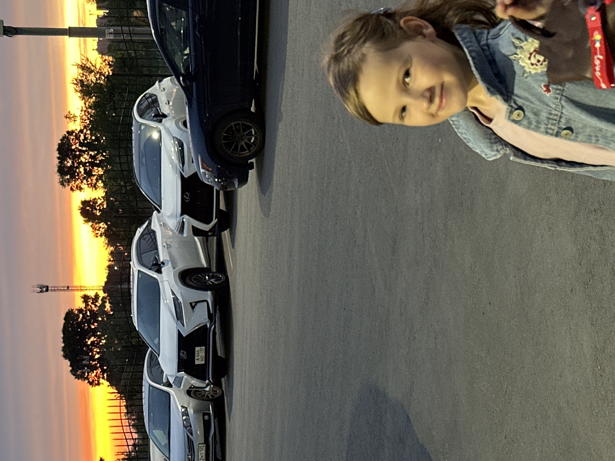 Girl and cars photographed during stunning Khabarovsk sunset