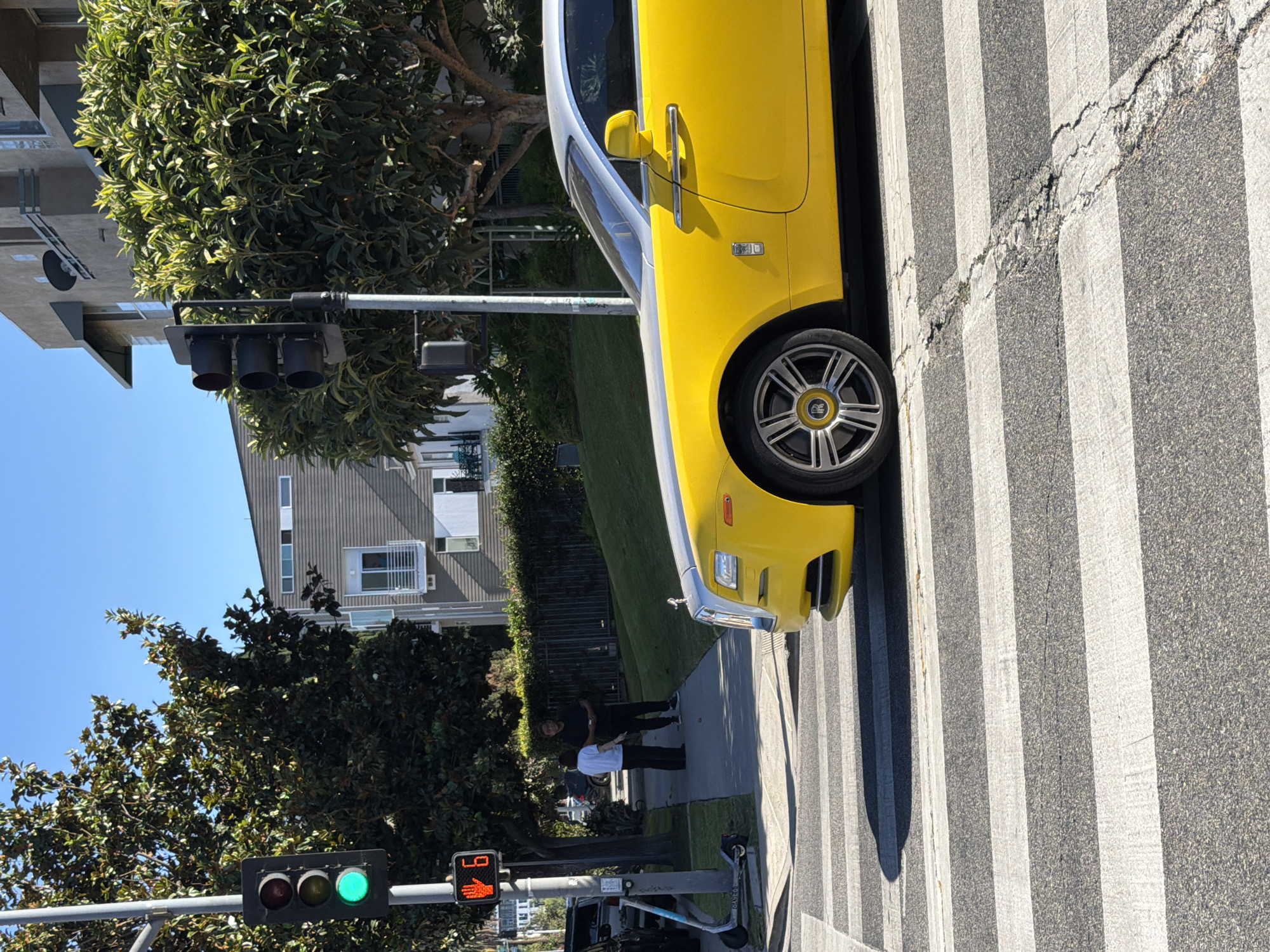 Yellow Rolls-Royce parked on a sunny LA street