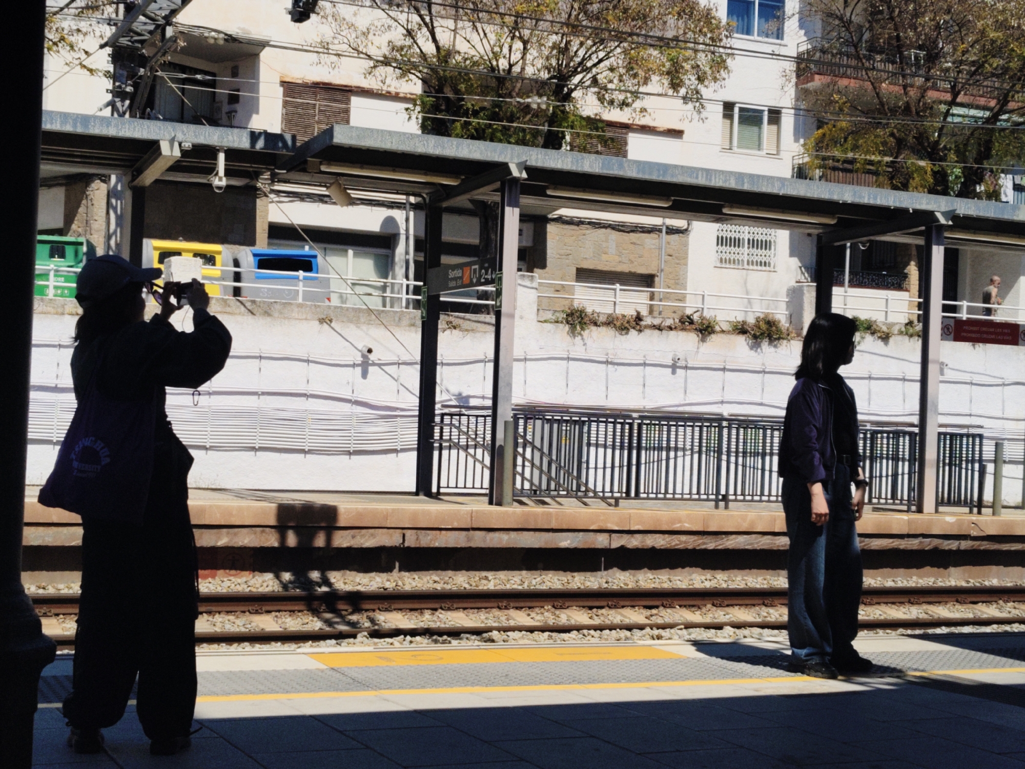 Two people spotted on sunny Sitges train platform