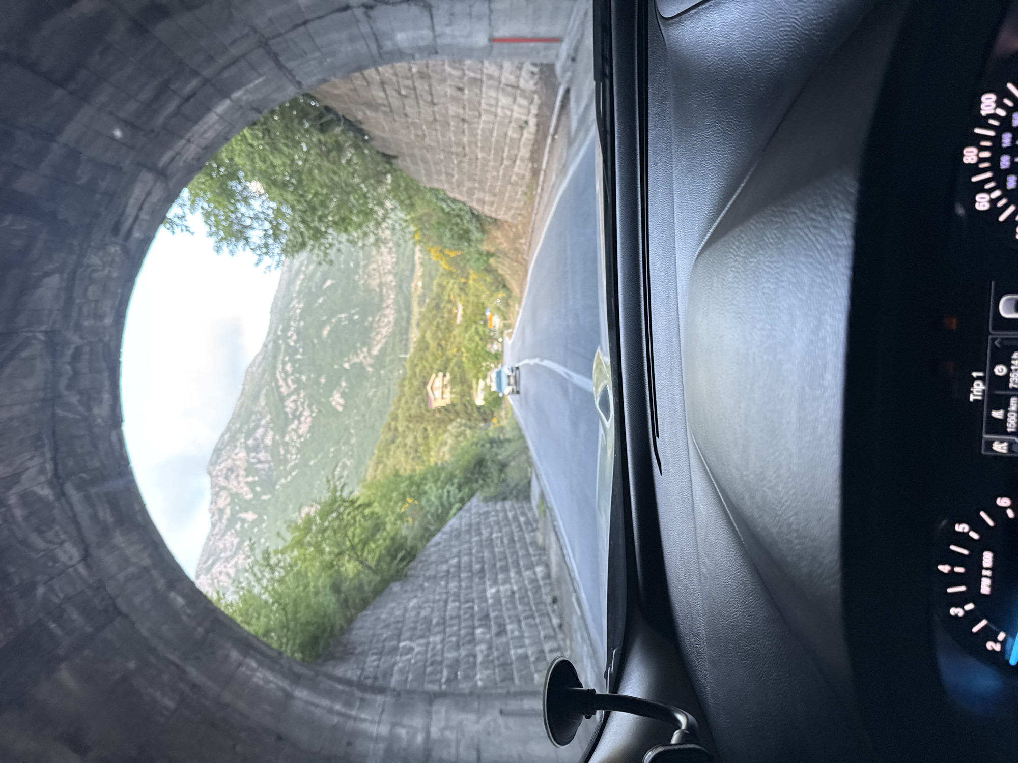 Driver travels through stone tunnel in Montenegro mountains