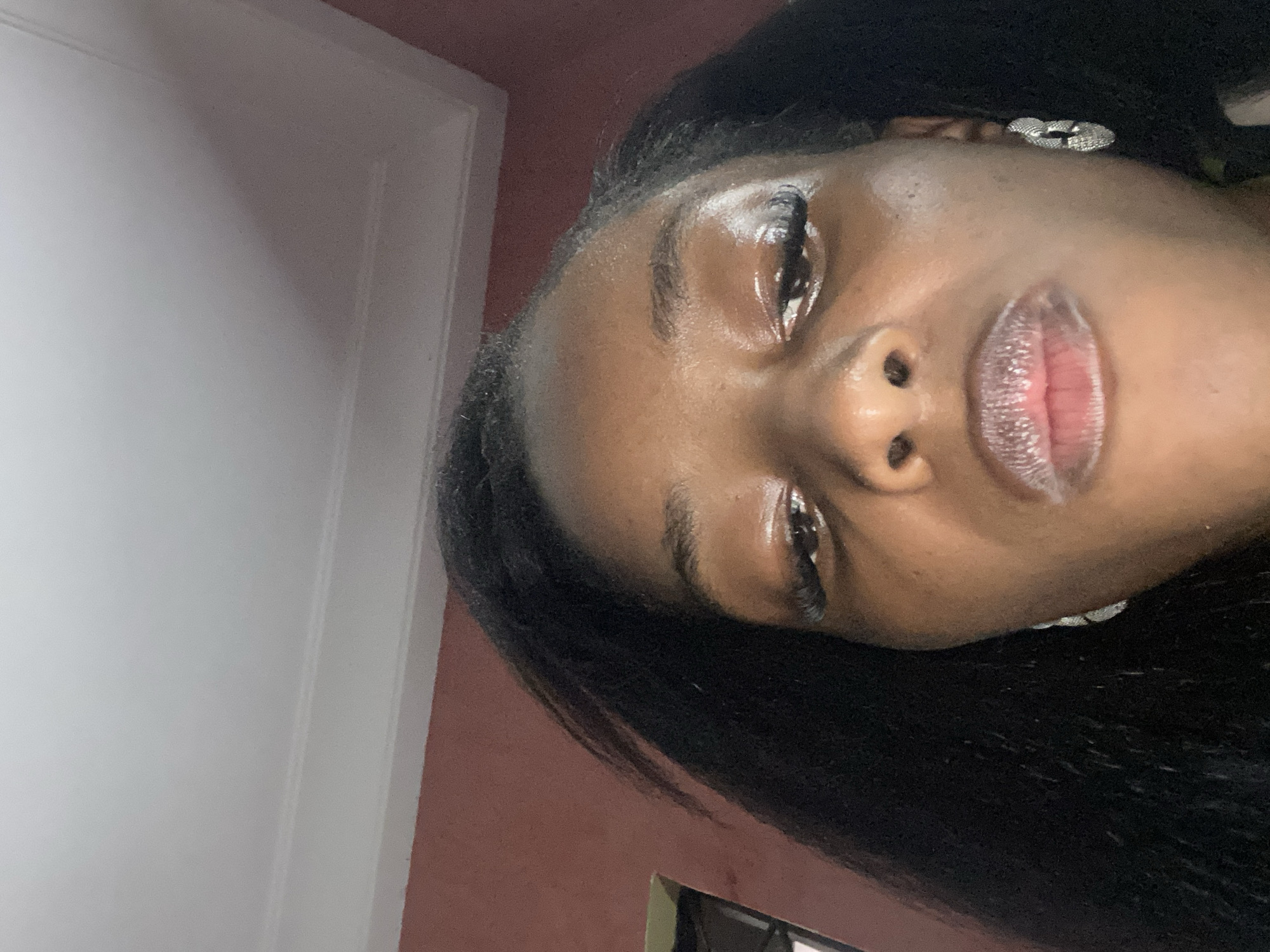 Woman photographs herself eating french fry indoors in Jos