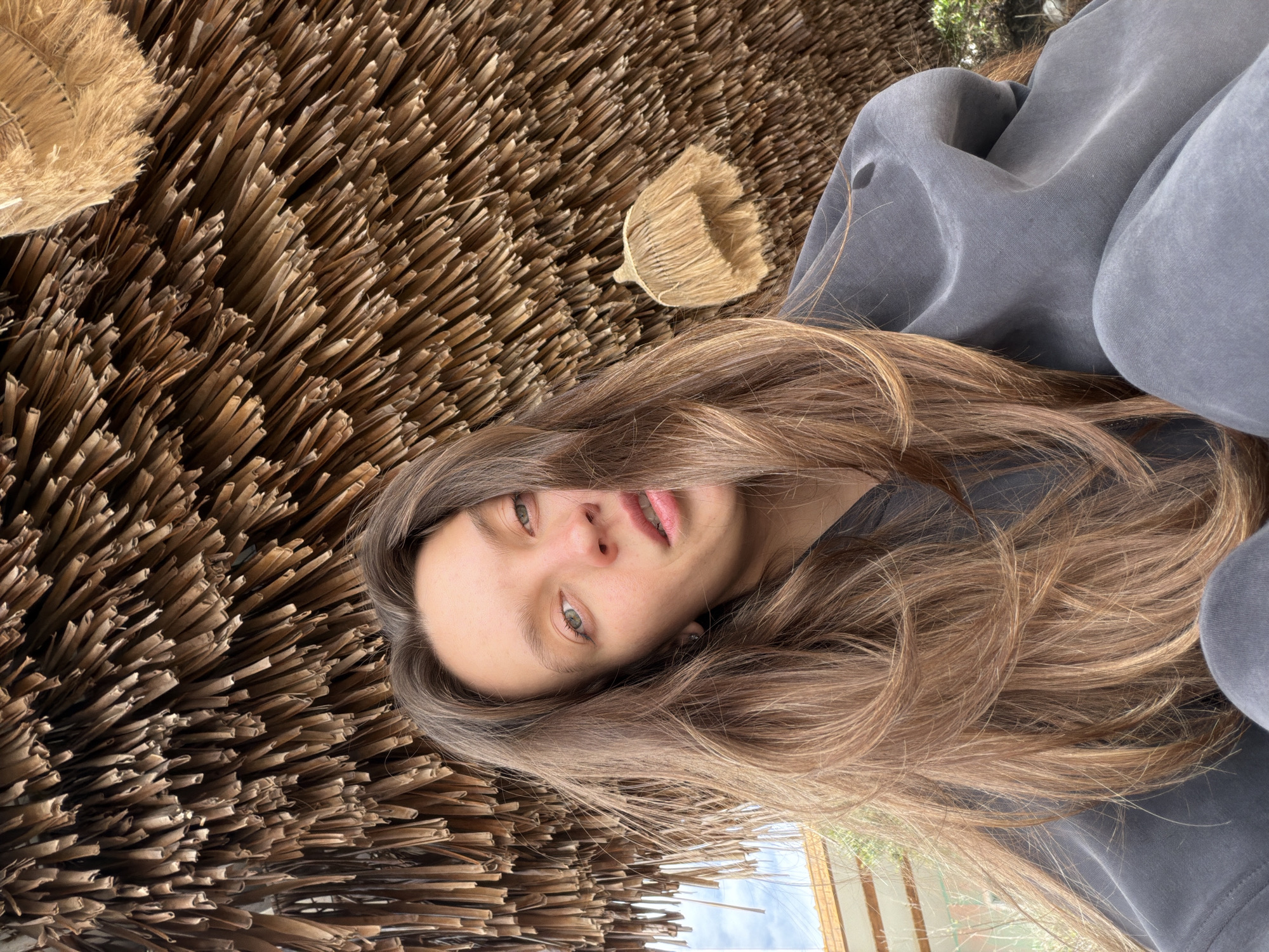 Woman rests on straw bundles in Montenegro village