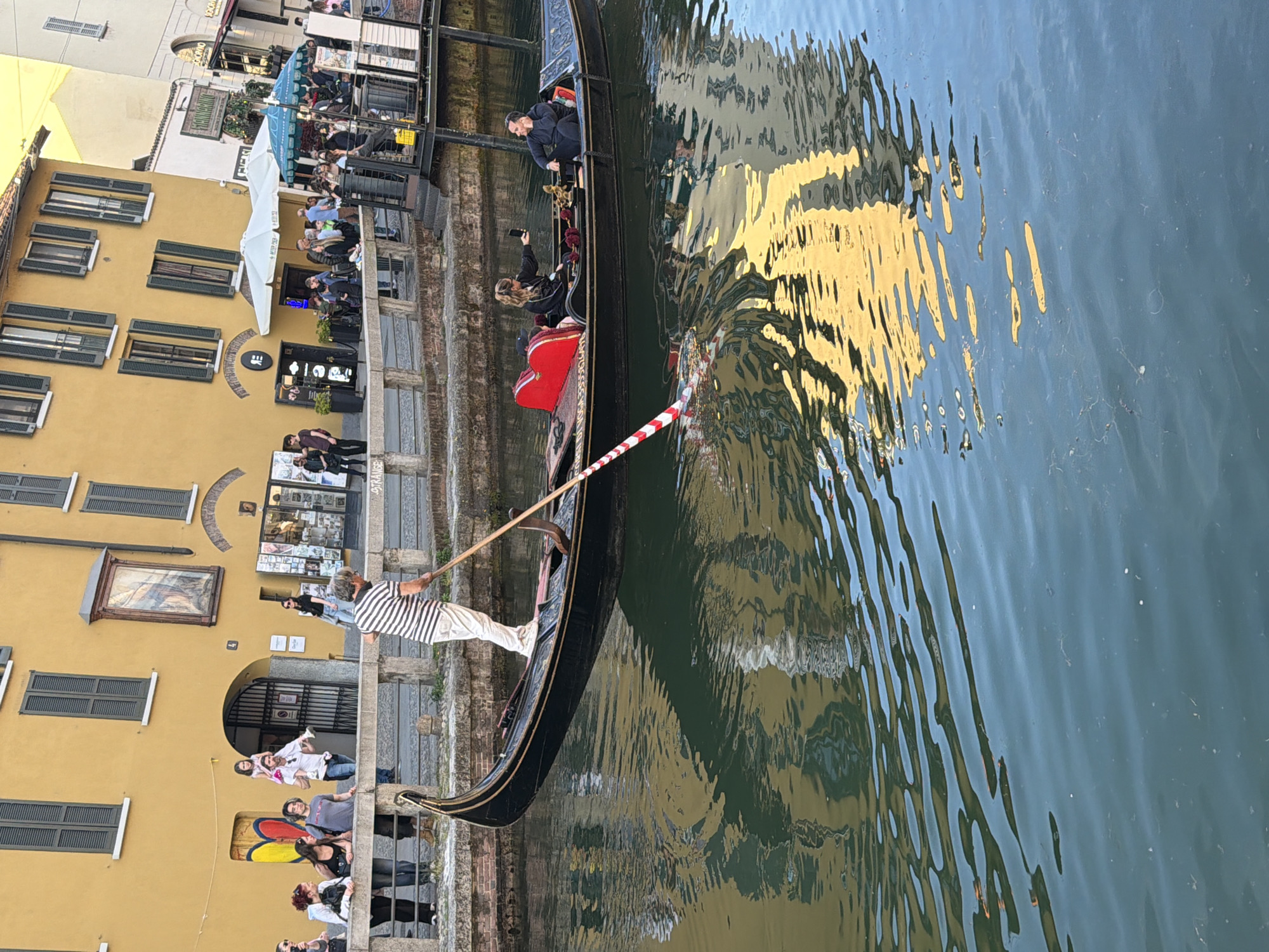 Gondola carries passengers through Milan's Navigli canal district