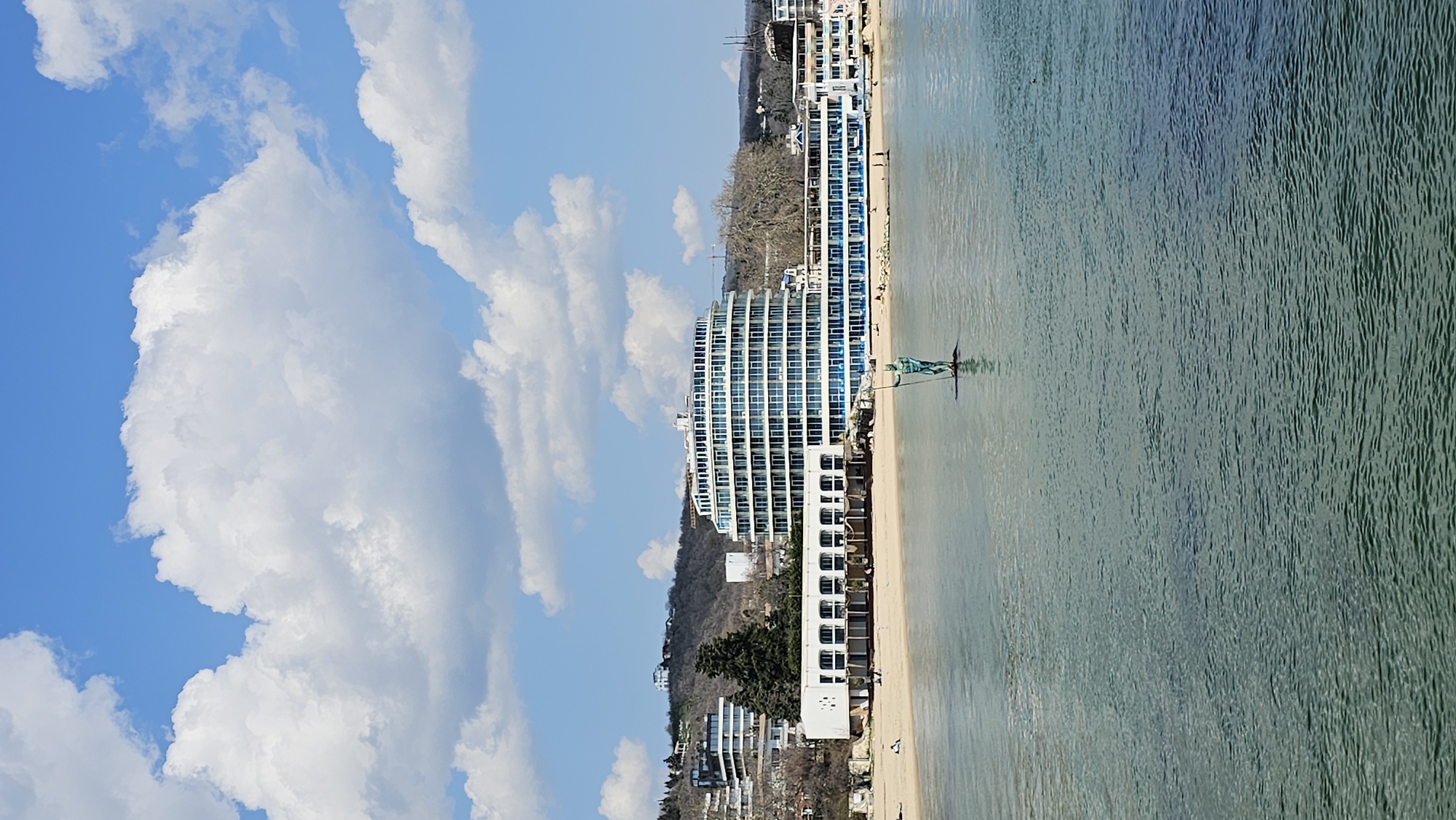 Tourist documents Varna coastline sculptures, dining, buildings during morning visit