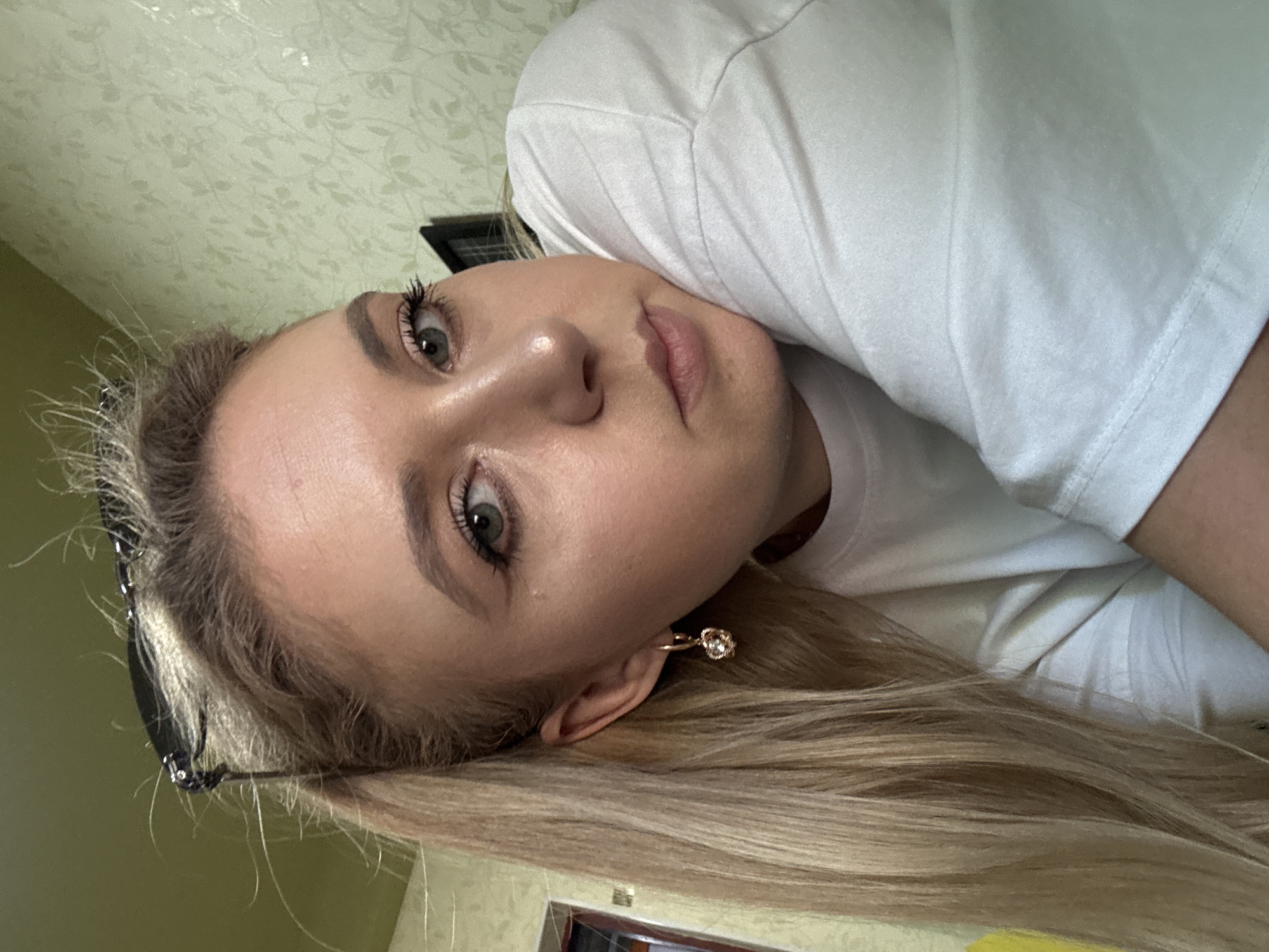 Selfie session indoors, white tee and gold jewelry throughout