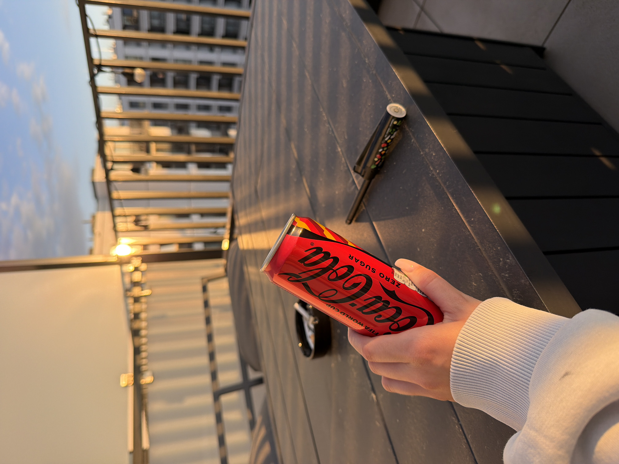 Rooftop sunset moment with motorcycle artwork and Coca-Cola