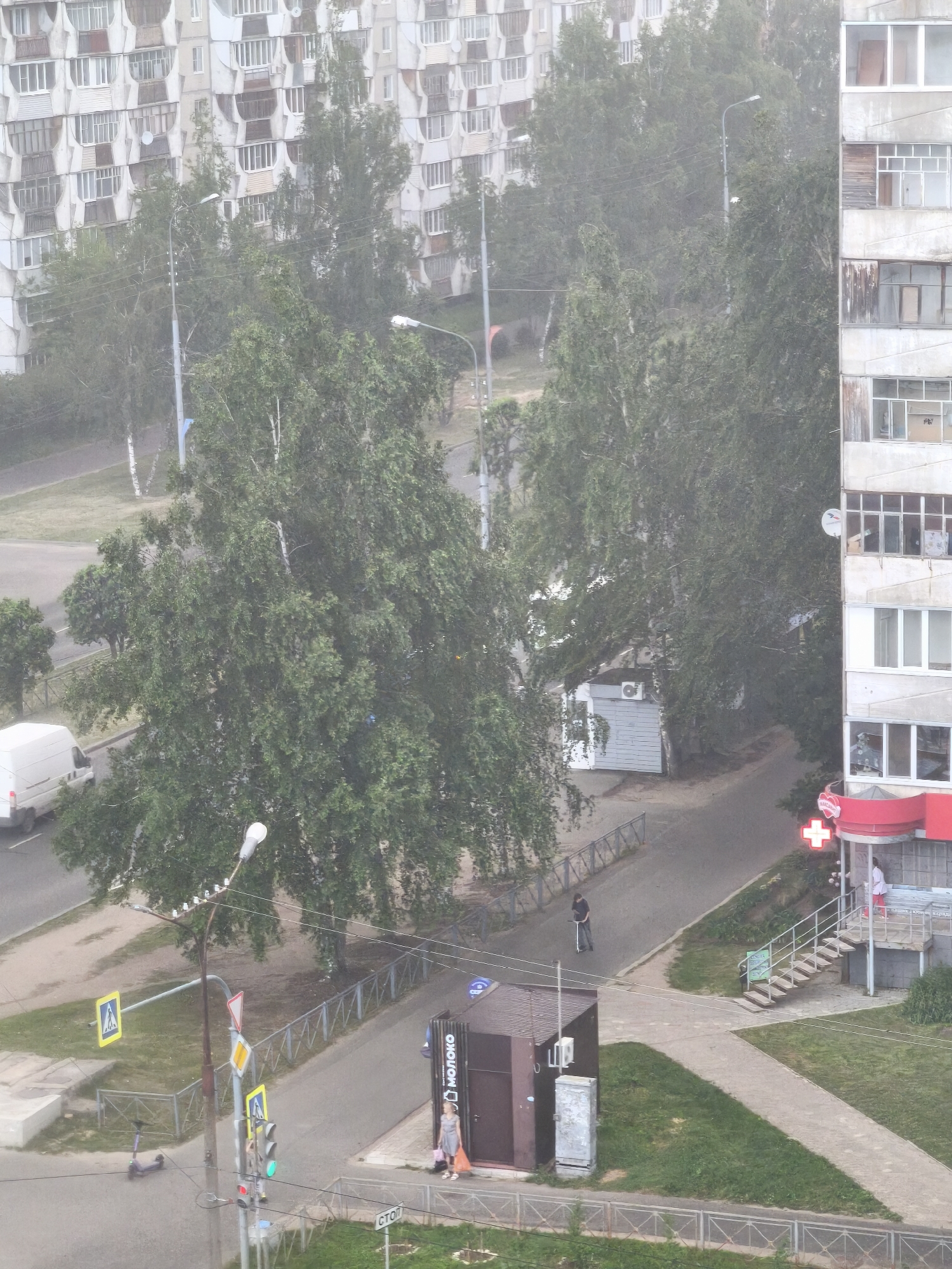 Resident documents rainy afternoon across Yoshkar-Ola apartment districts