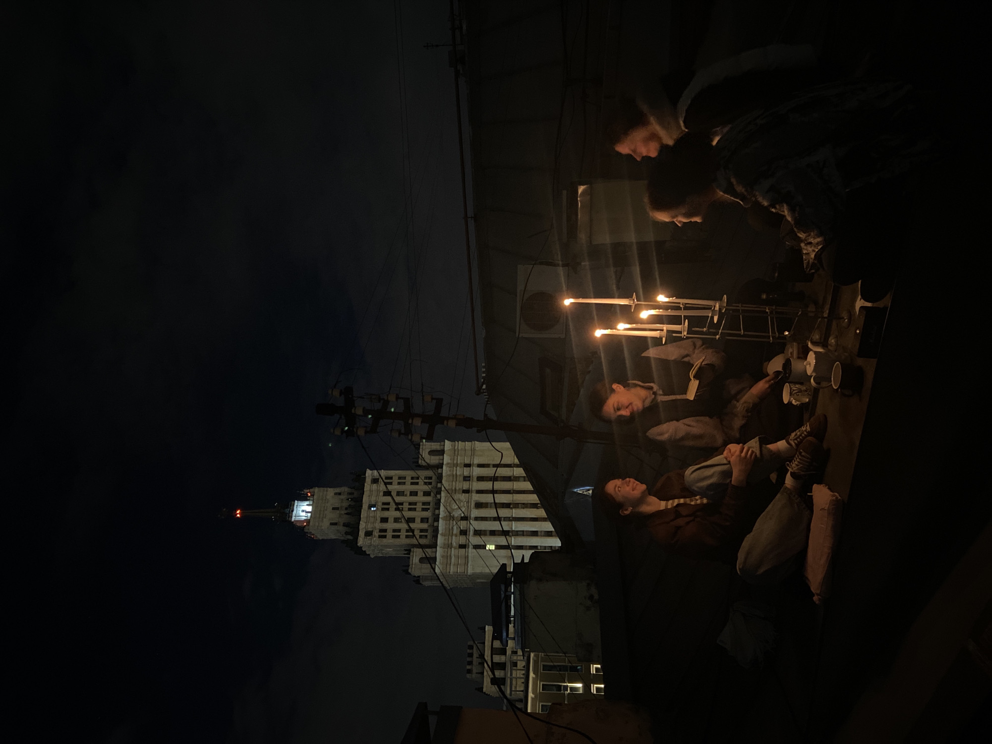 Friends gather for candlelit rooftop evening in Moscow