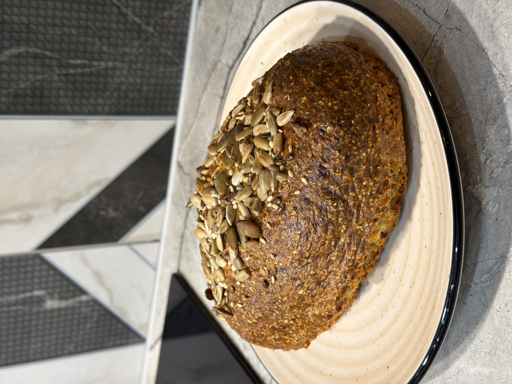 Home baker documents fresh seeded bread preparation in Ryazan