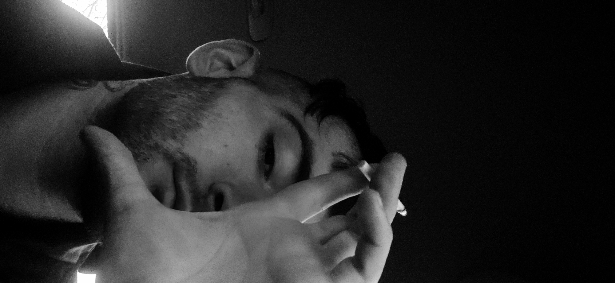 Person photographed smoking in artistic black-and-white shots, Bulgaria