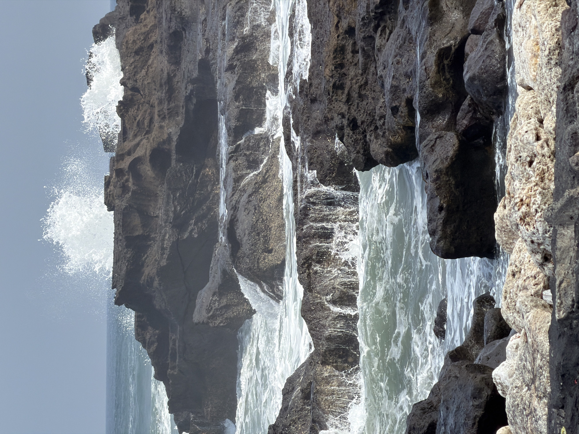Clifftop cafe and rocky shoreline on Bali's coast