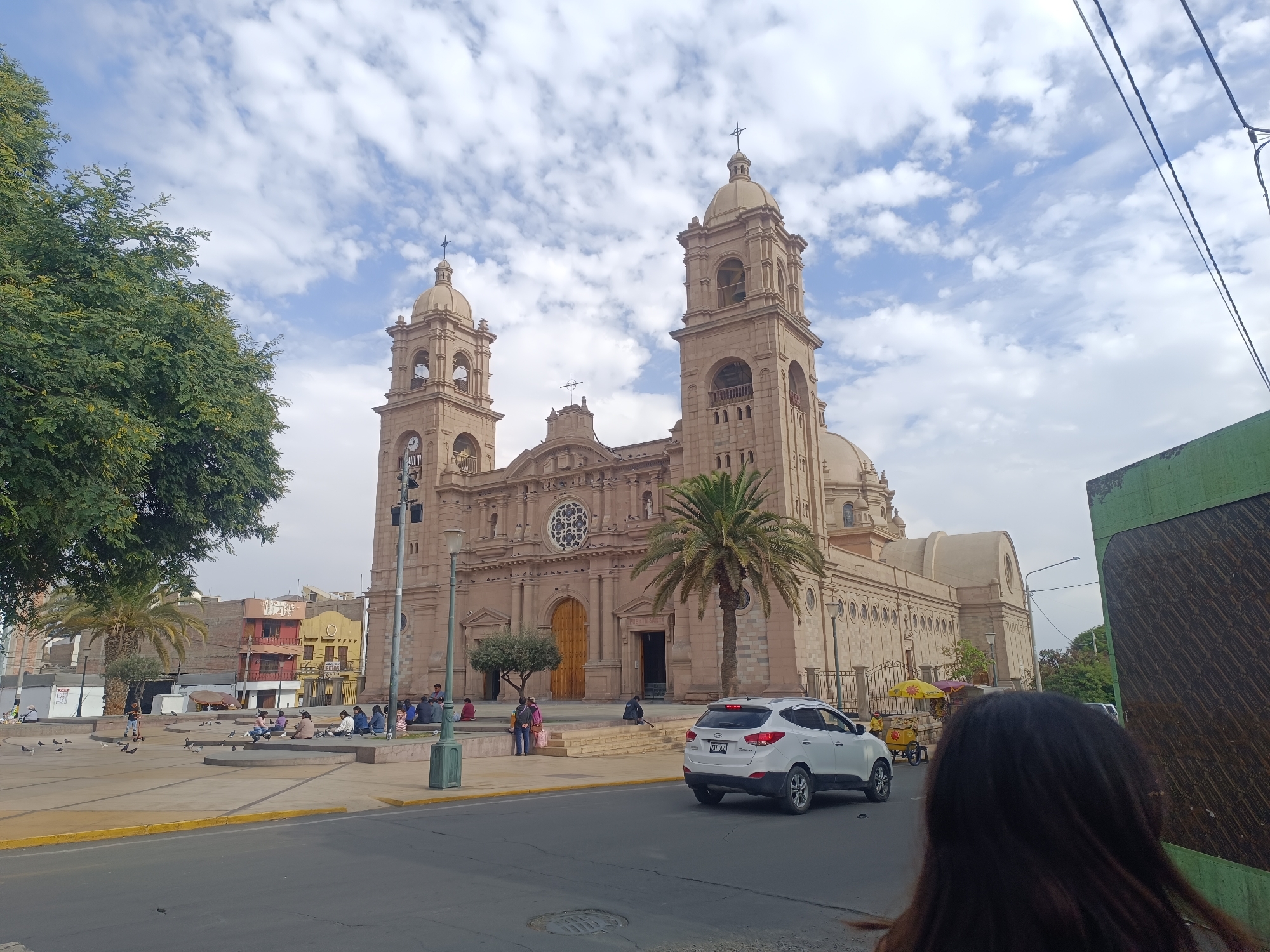 Tourist documents Tacna Cathedral and public spaces during afternoon visit