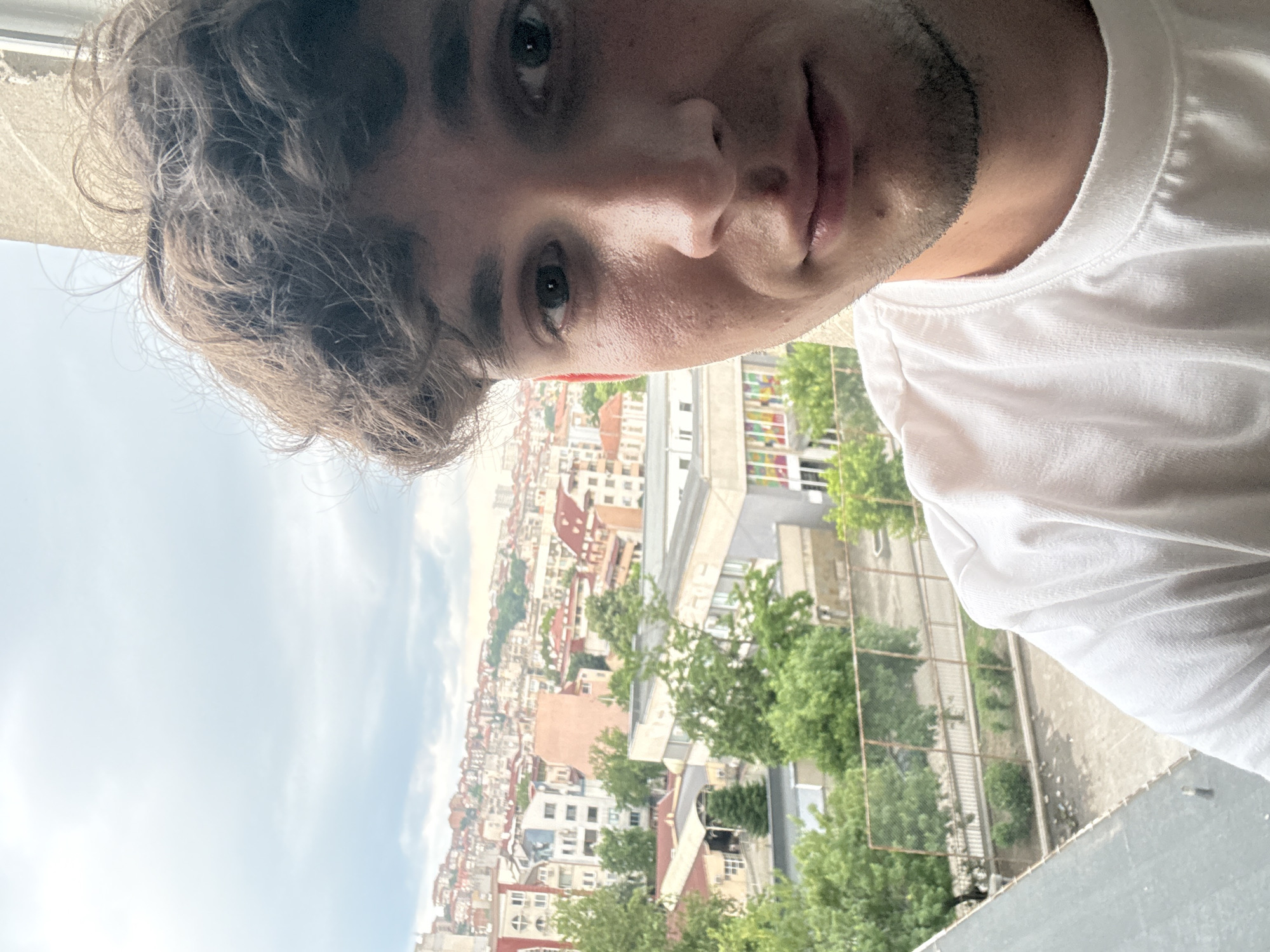 Young man photographed against city backdrop in Haskovo, Bulgaria