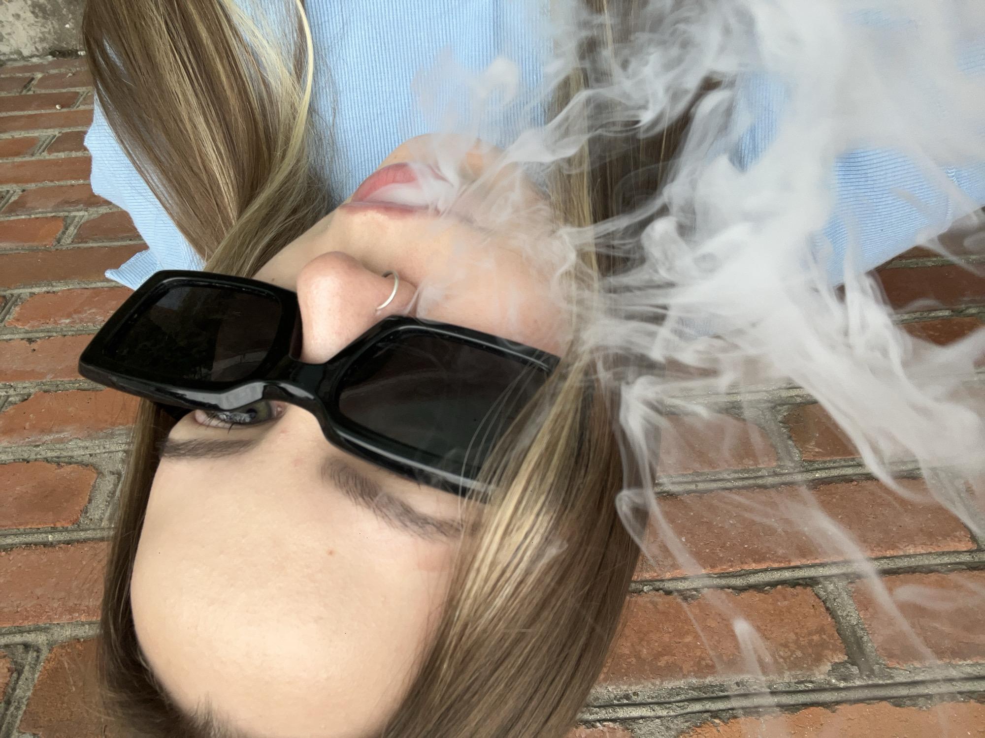Afternoon moments captured in Russian village: woman vaping, pets, gardens