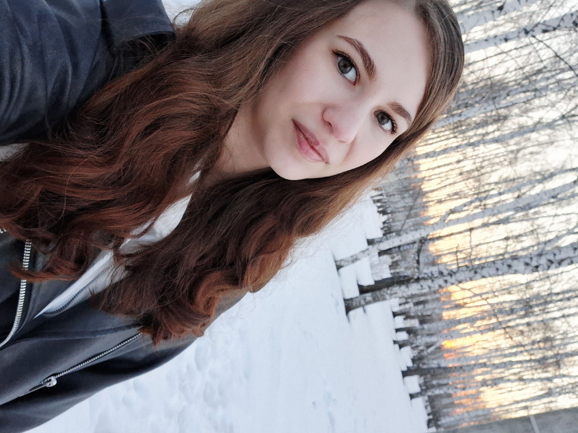 Young women pose for photos along snowy Kama River