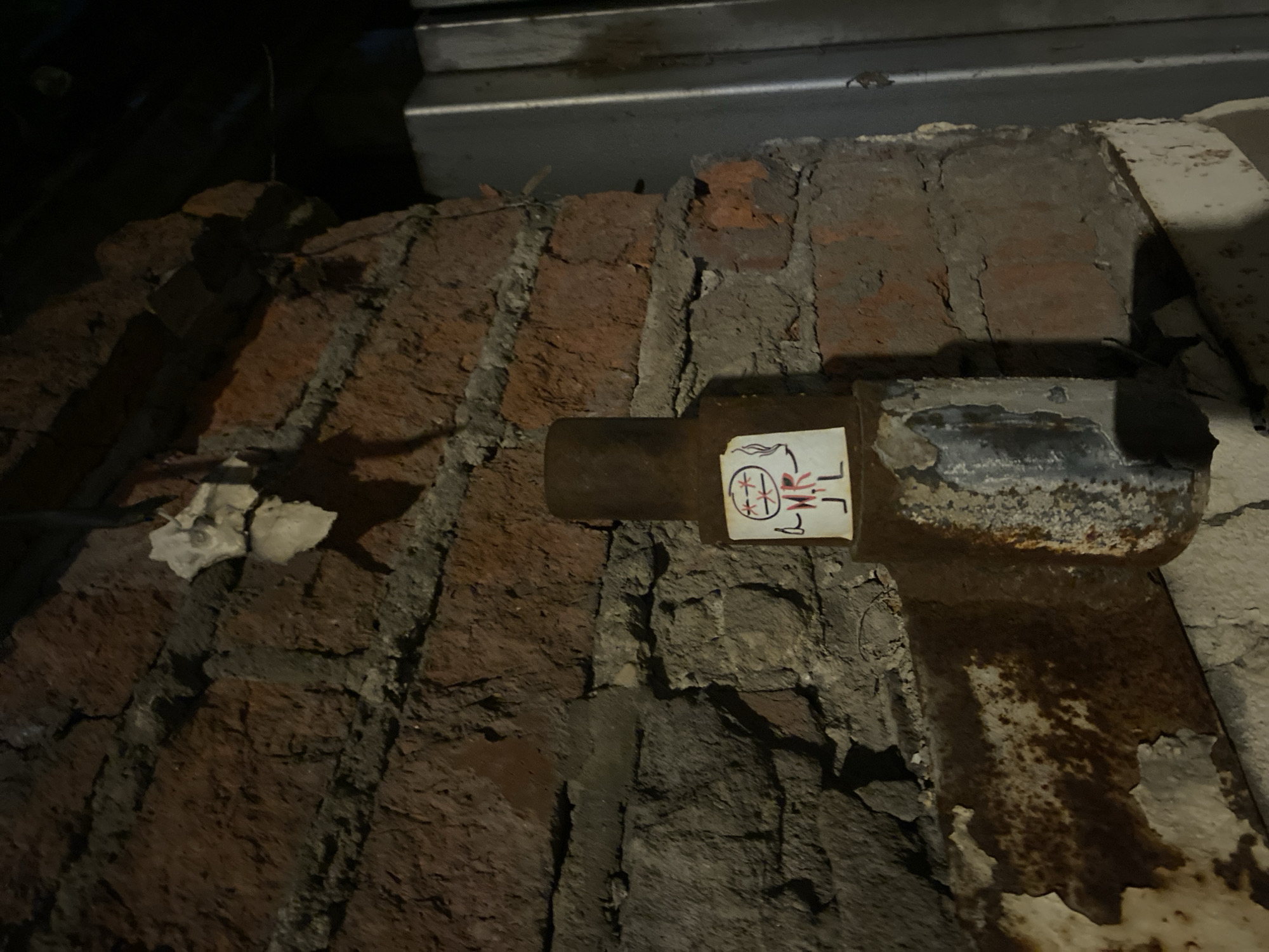 Moscow building shows crumbling wall, pipe with sticker