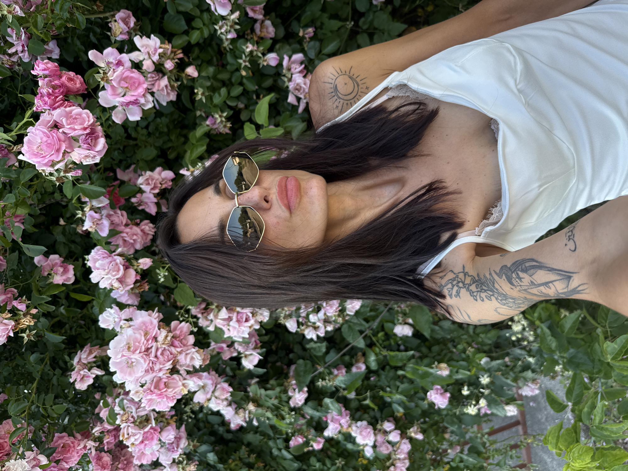 Woman takes selfie among pink flowers in Pleven