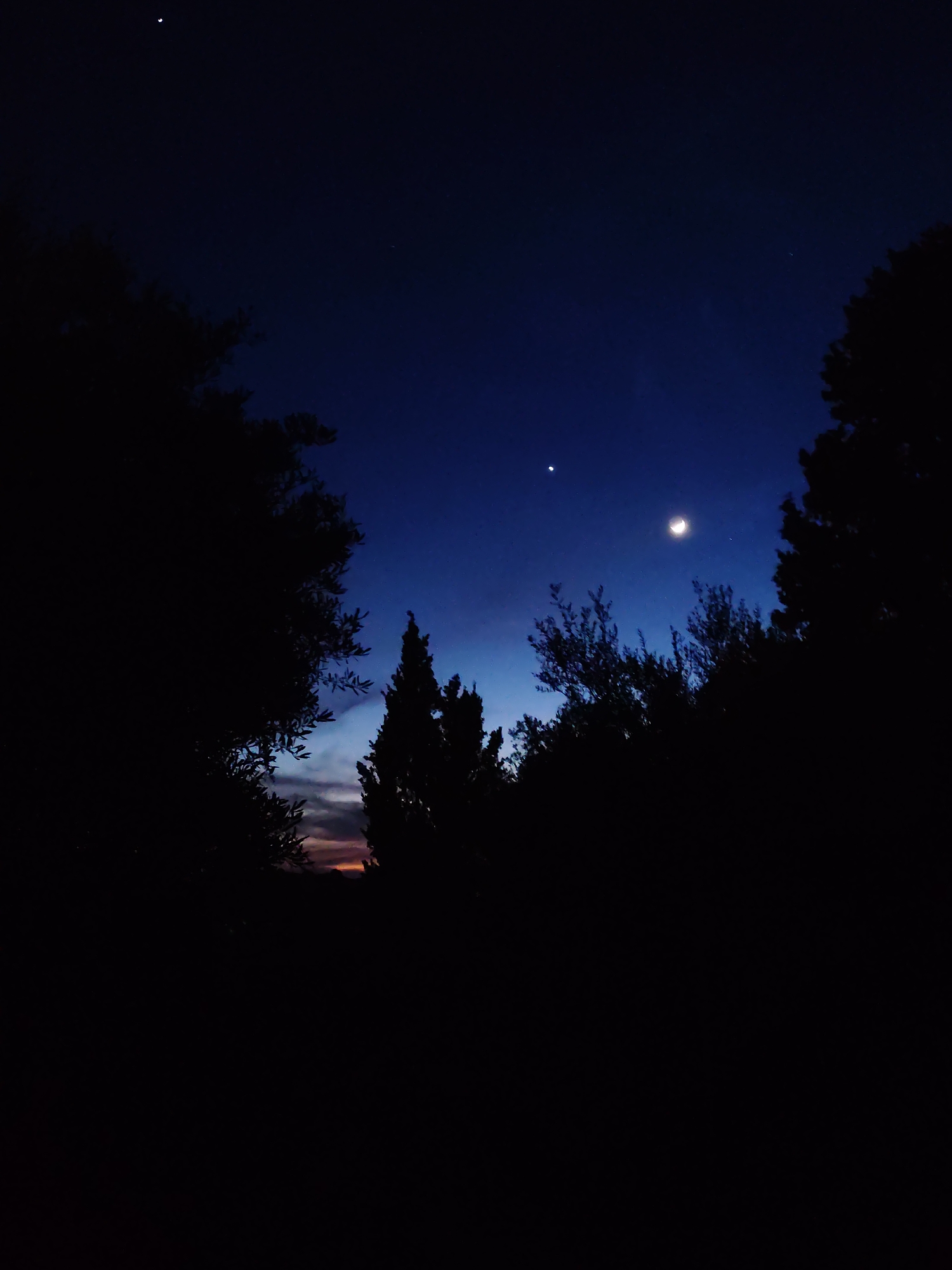 Crescent moon and bright planet observed in evening sky
