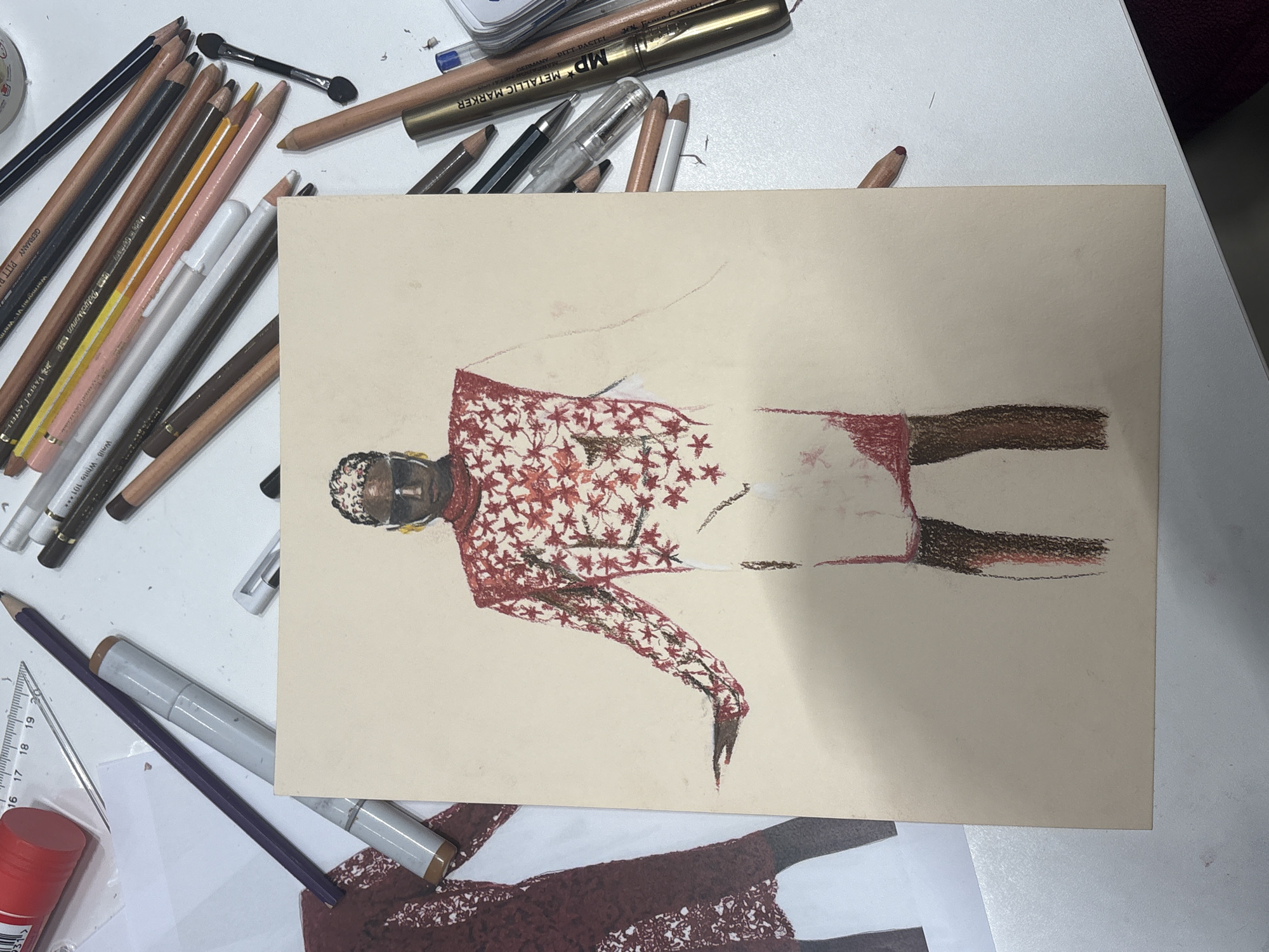 Fashion sketch spotted on Milan tabletop amid art supplies