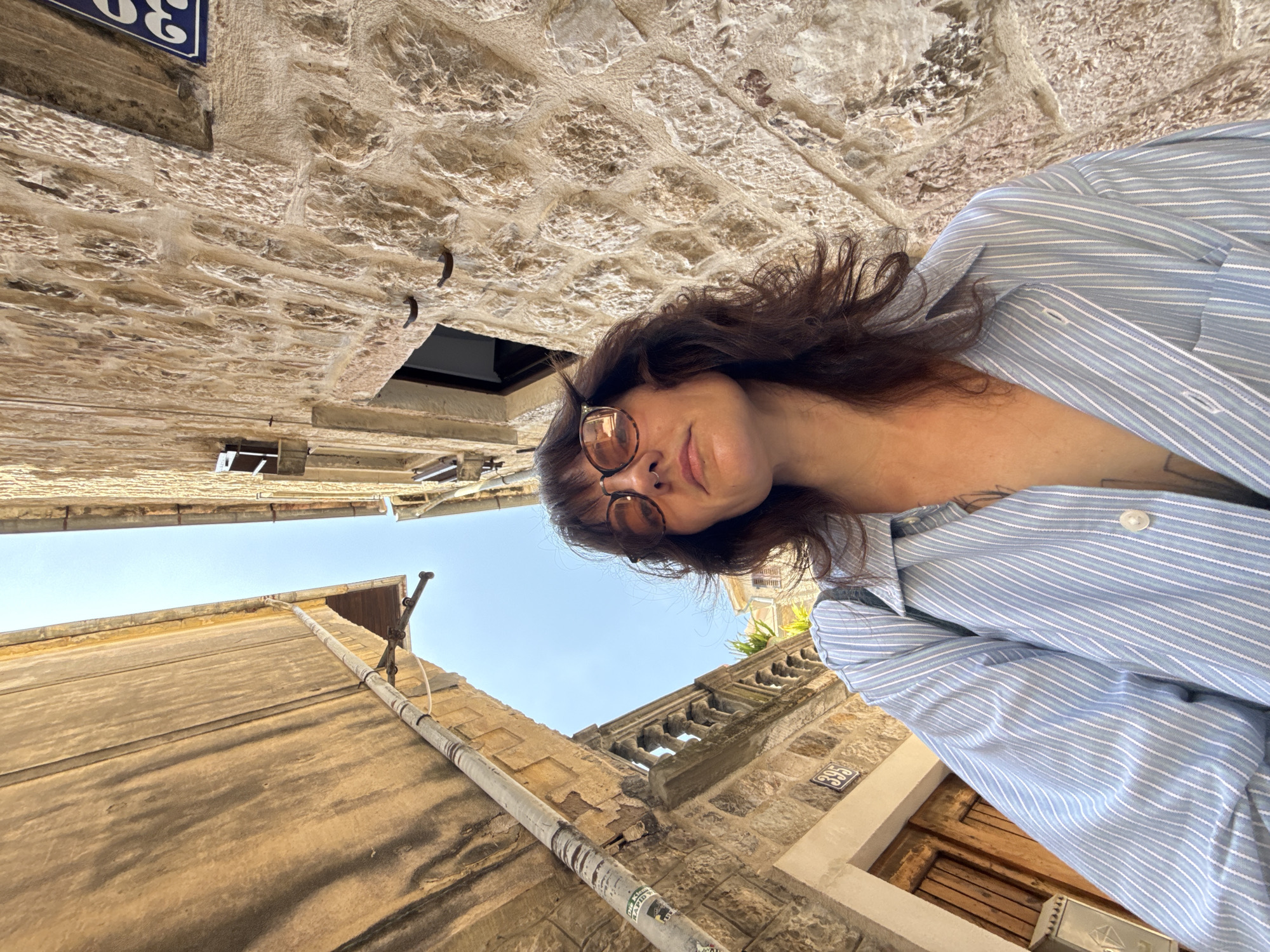 Woman explores historic Kotor fortifications and cobblestone streets