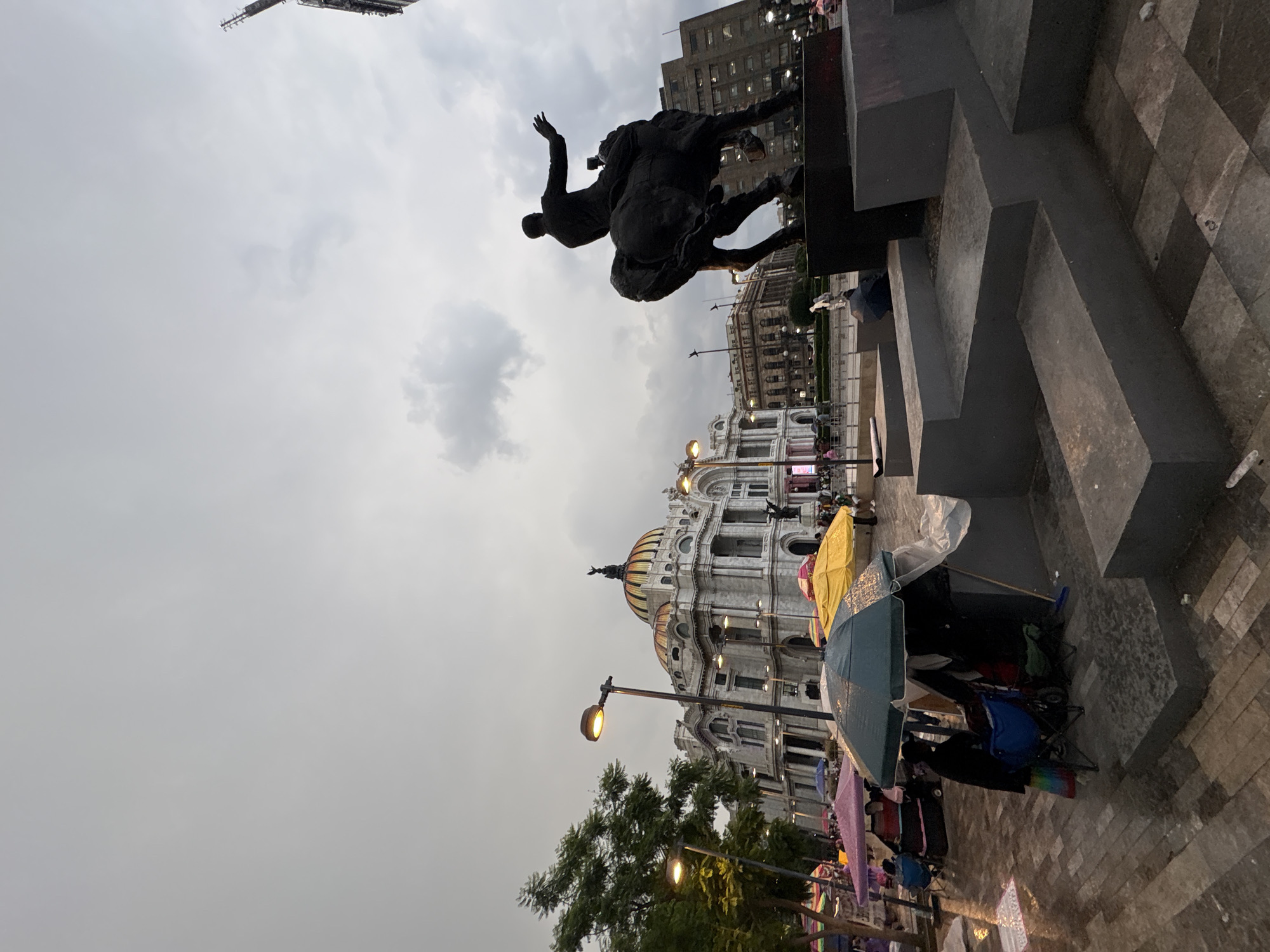 Mexico City's historic center amid market stalls and protest imagery
