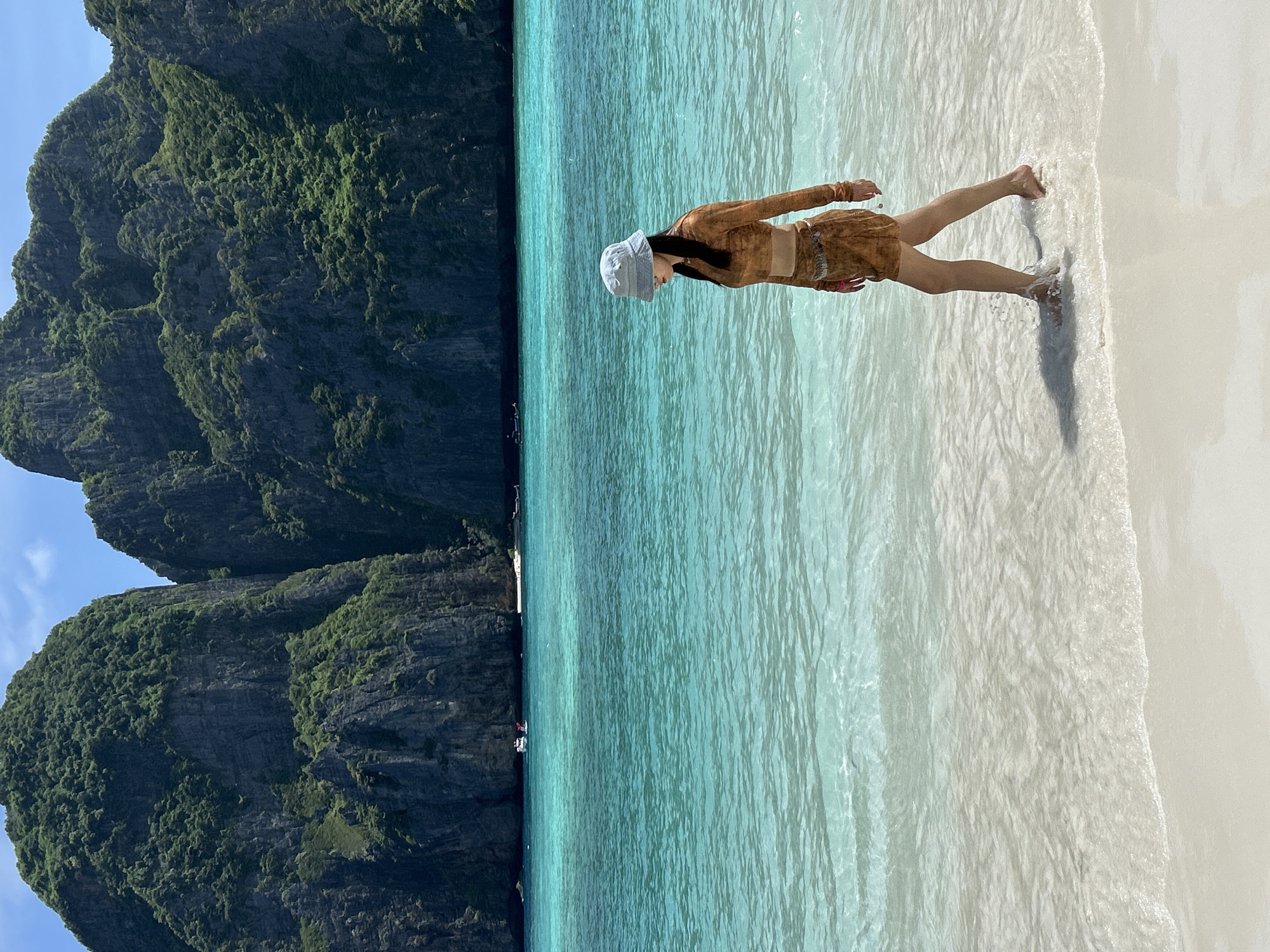 Strolling Ao Nang's turquoise shoreline in tropical summer heat