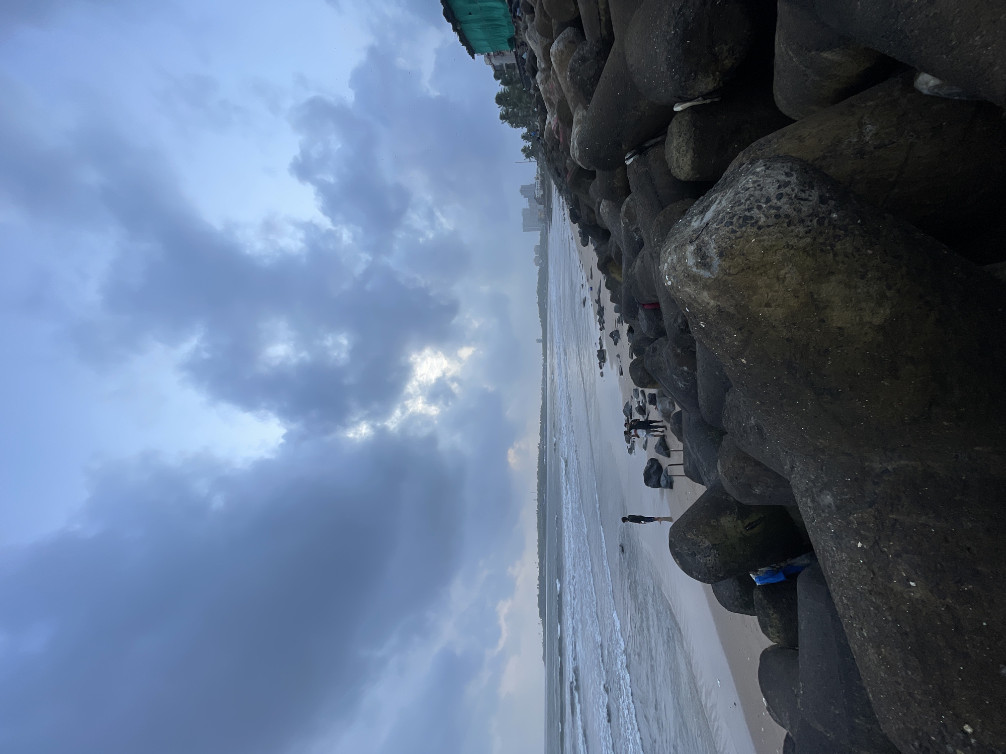 Mumbai's coastline under monsoon skies, tetrapods and rough seas