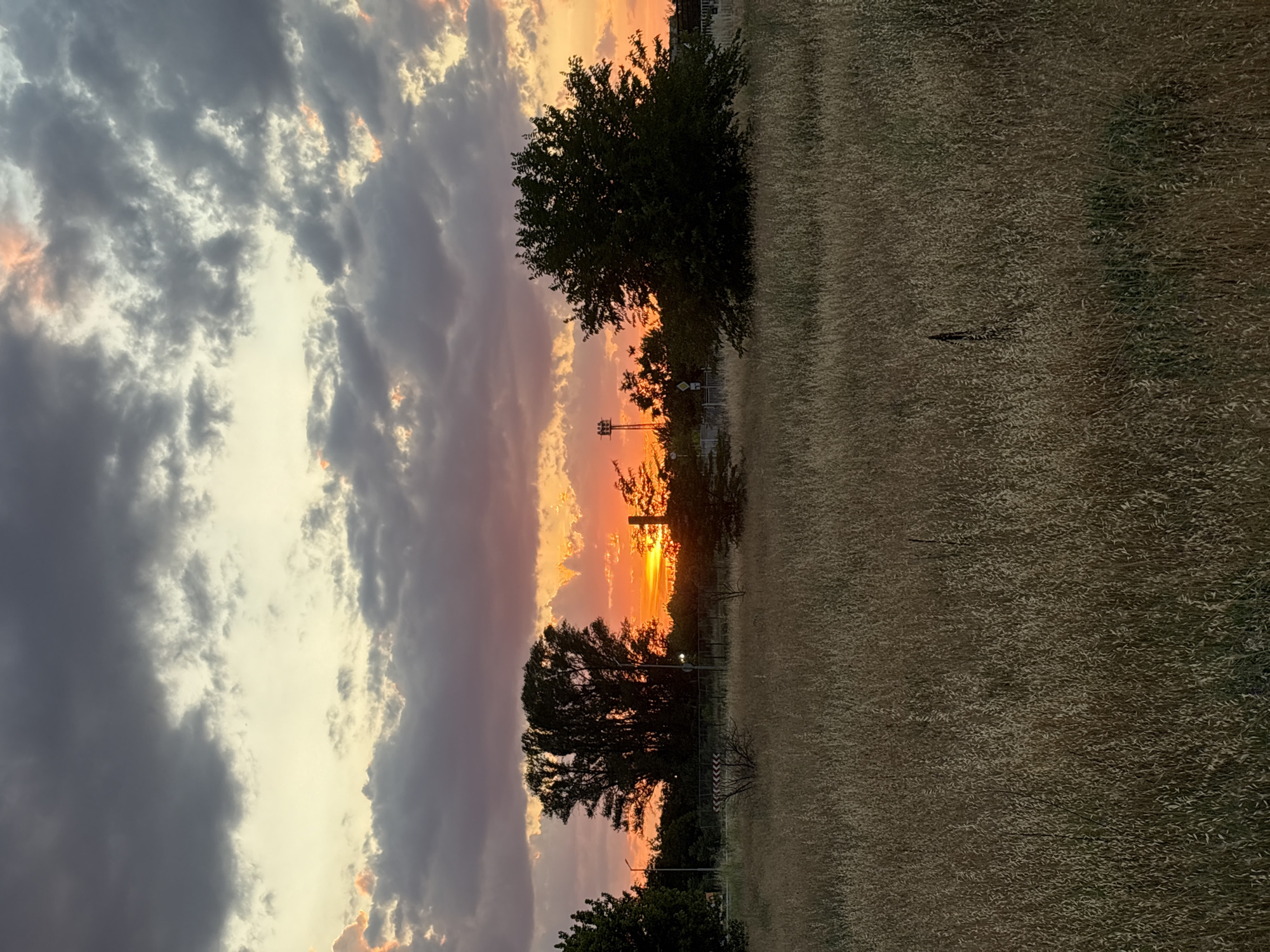 Sunset over dry fields and industrial silhouettes in Stamboliyski