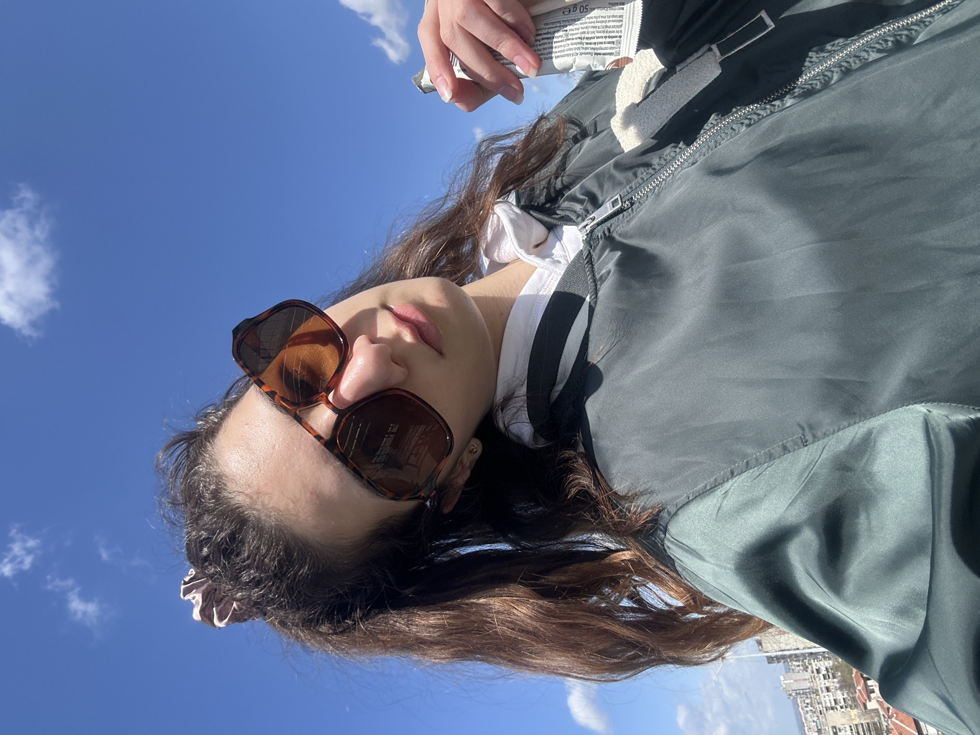 Woman photographed with package under blue sky in Ruse