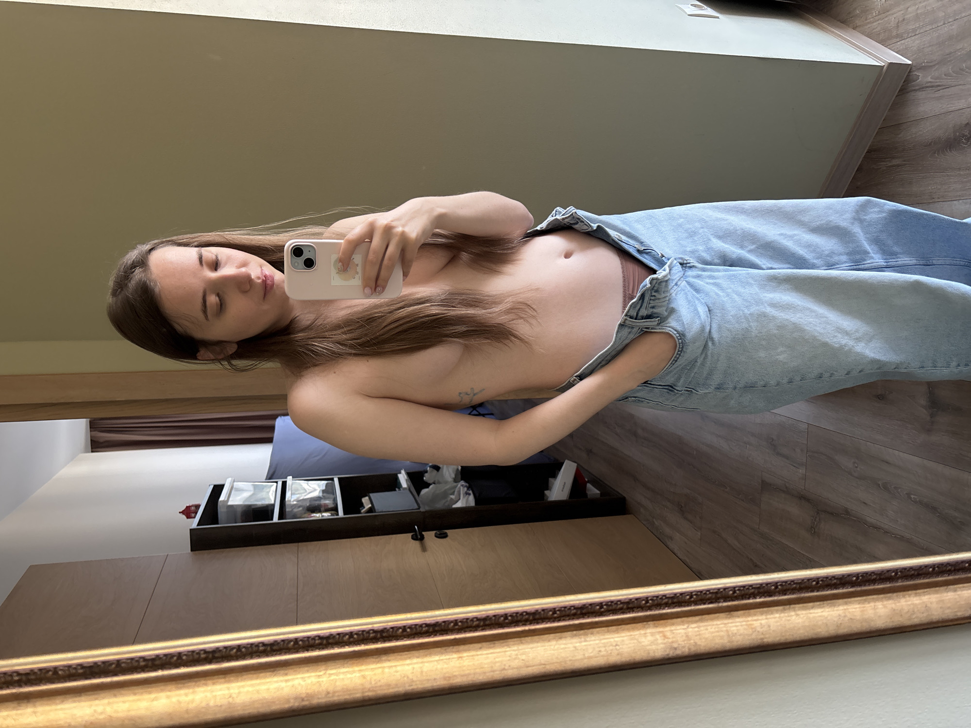 Woman takes mirror selfie in Tbilisi bedroom