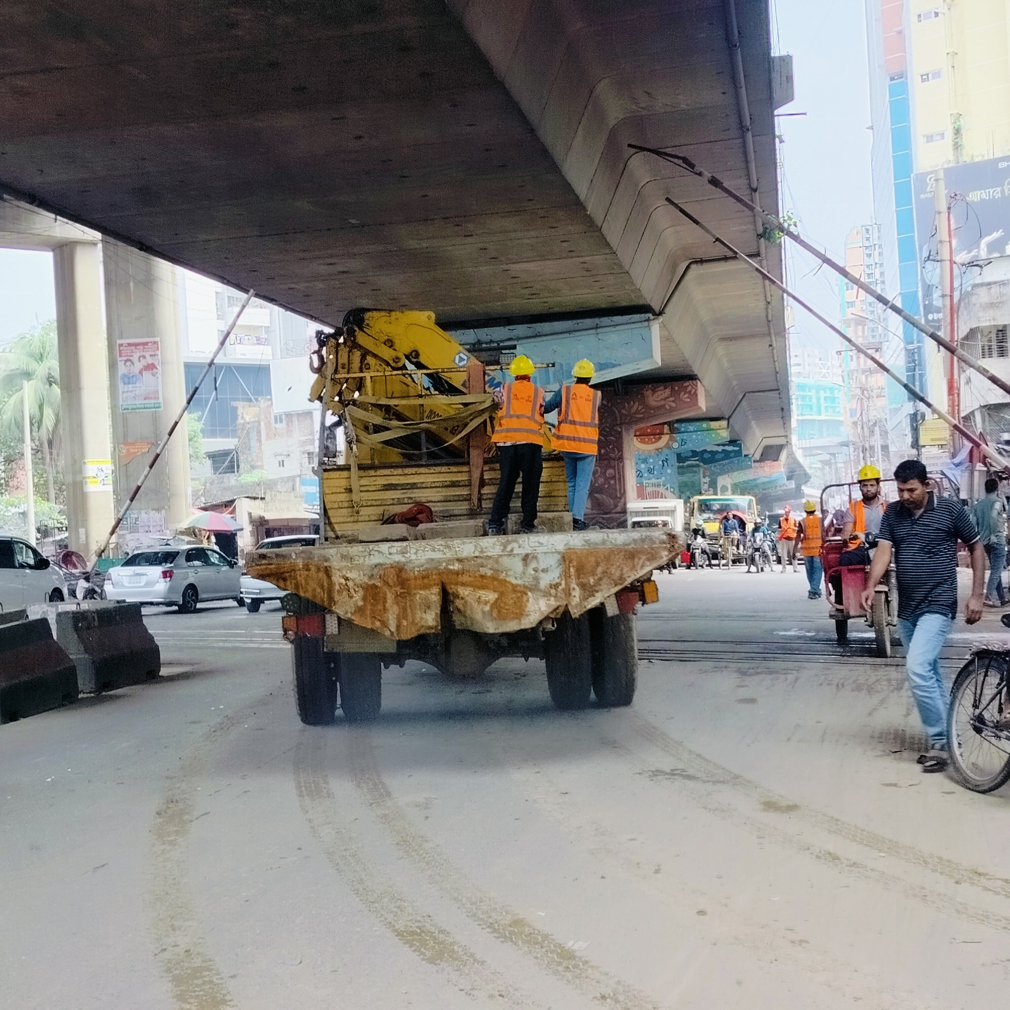 Construction workers in safety gear observed on Dhaka street