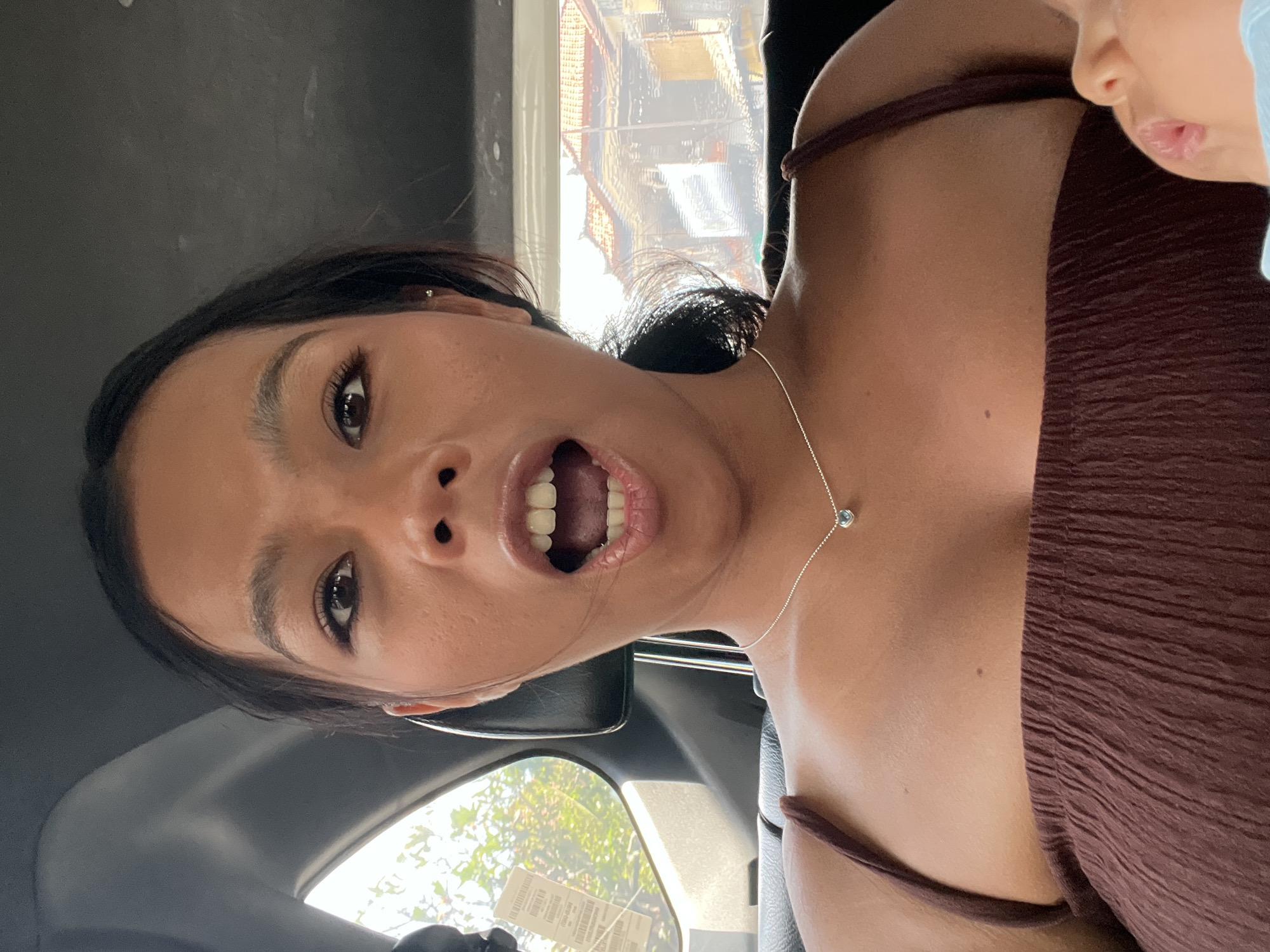 Passengers take selfies during early morning car ride in Kuta