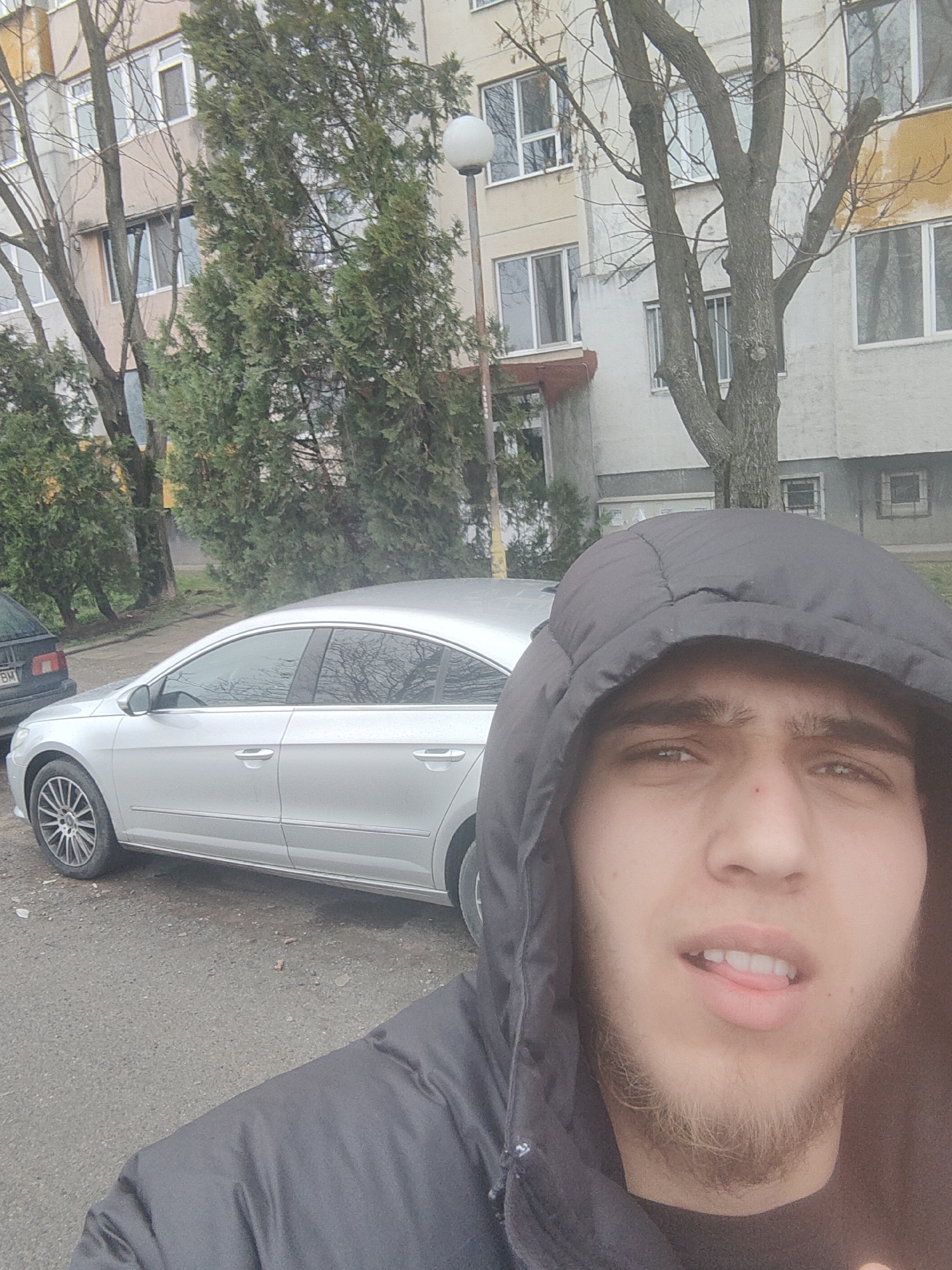 Man takes selfies with silver car in Sofia