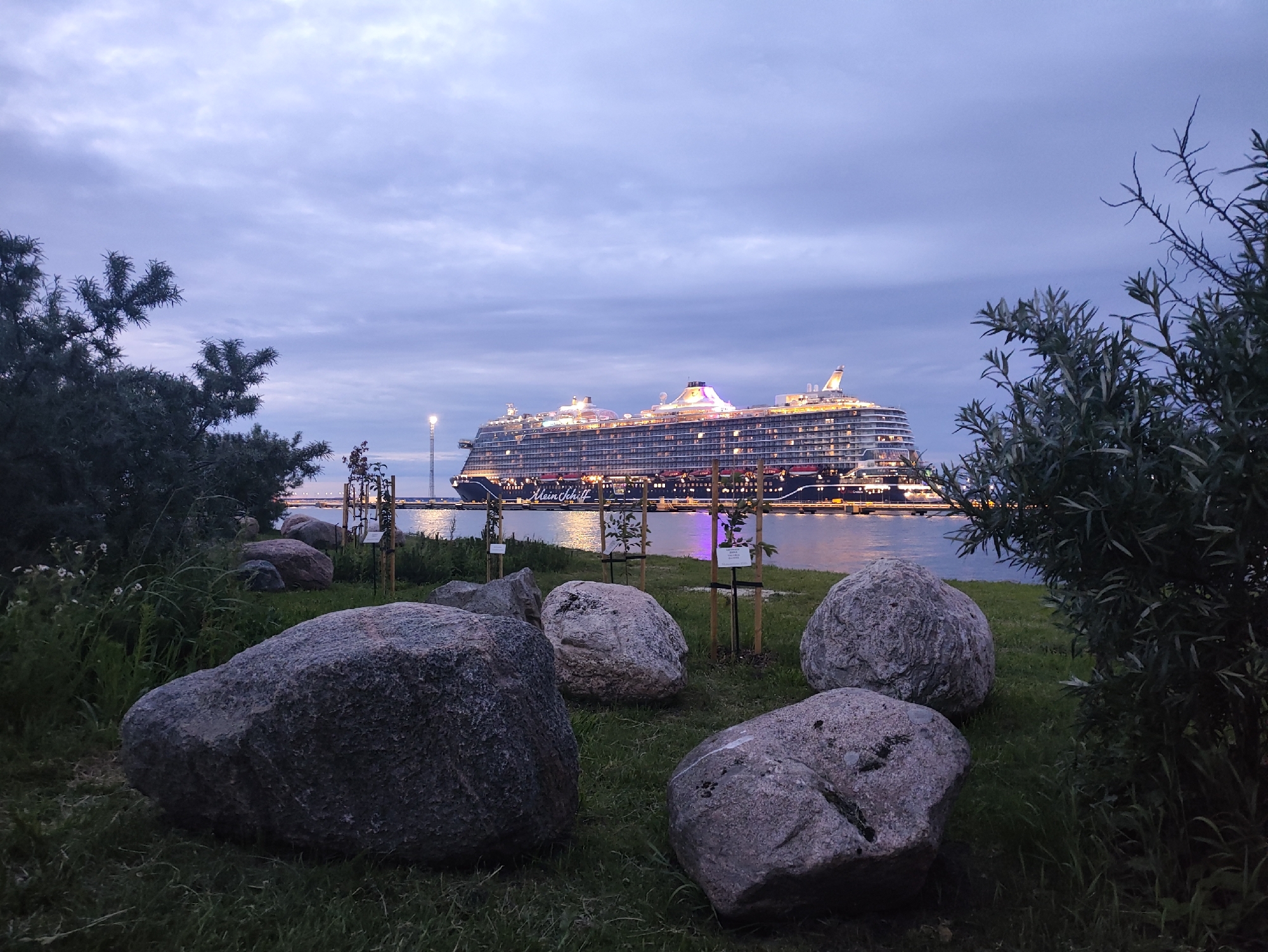 Cruise ships and ferries light up Tallinn harbor at dusk