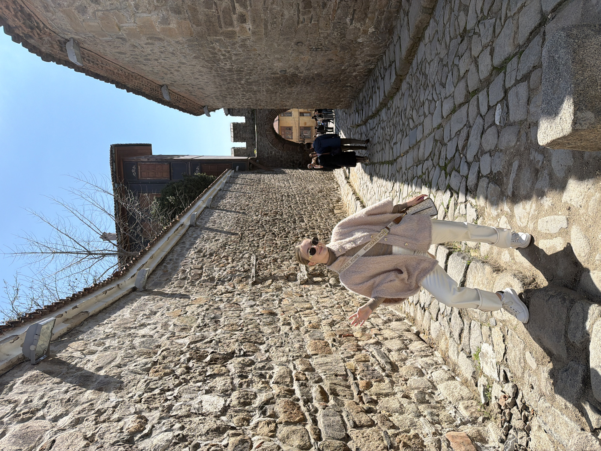 Woman walks cobblestone streets in historic Plovdiv Bulgaria