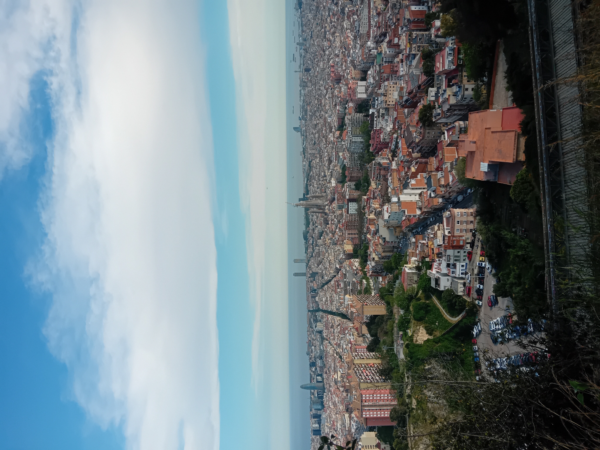 Panoramic view captures Barcelona cityscape extending to Mediterranean Sea