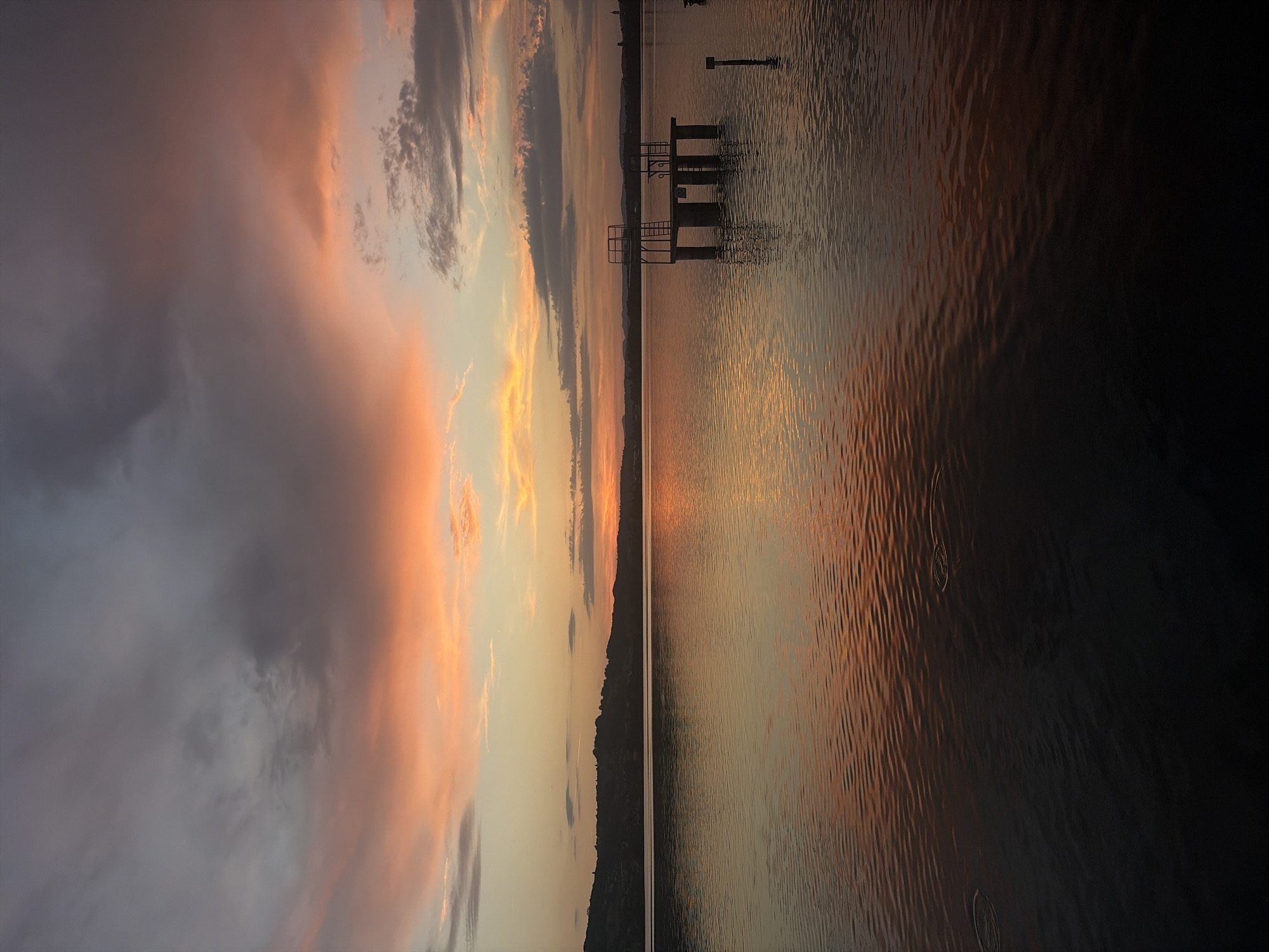 Golden hour at a Swiss lake, pier-side and in the water
